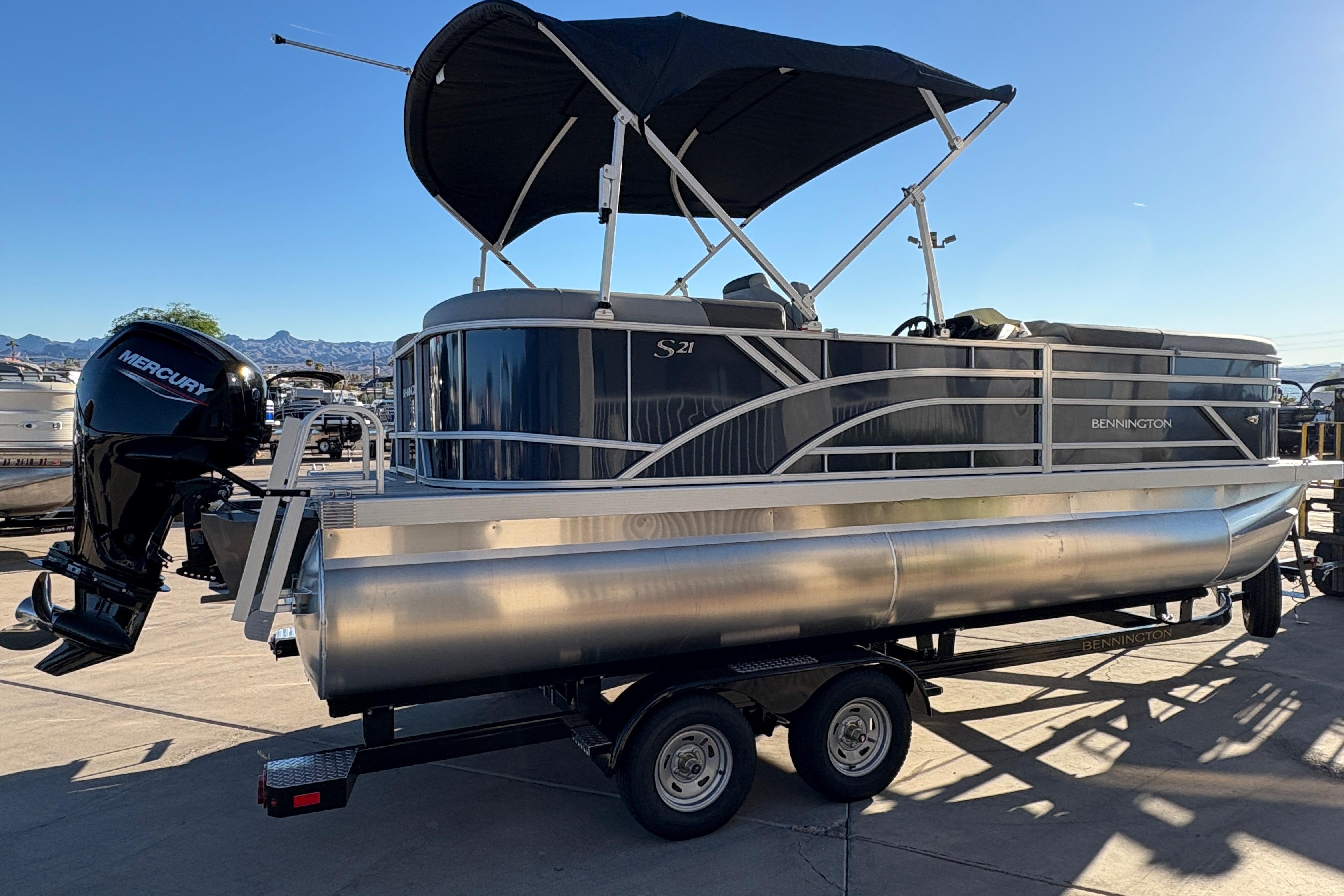 2026 Bennington 21 SSR pontoon boat with Mercury engine on trailer.