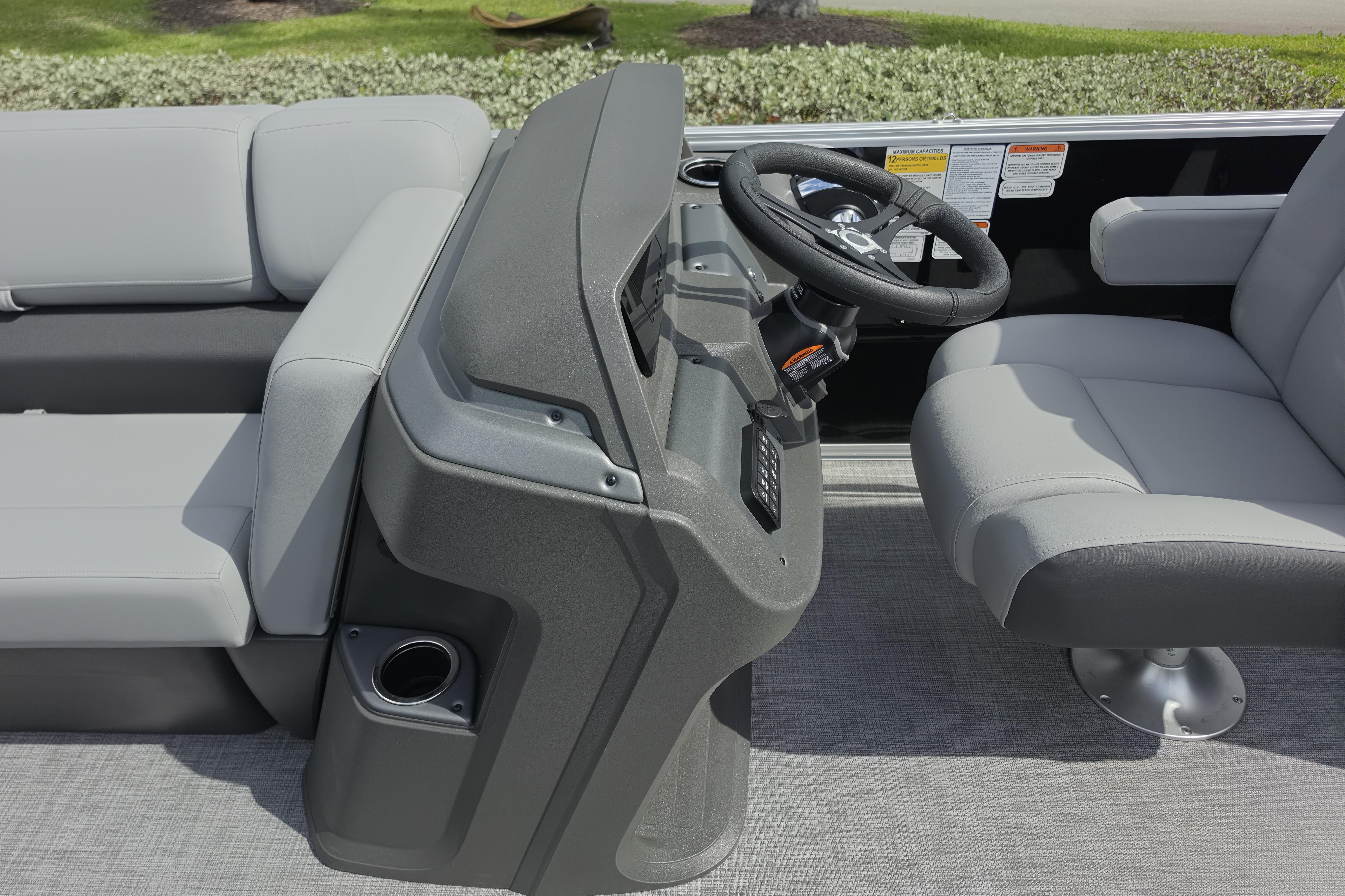 2026 Sun Tracker Party Barge 24 XP3 interior with steering console and seating.