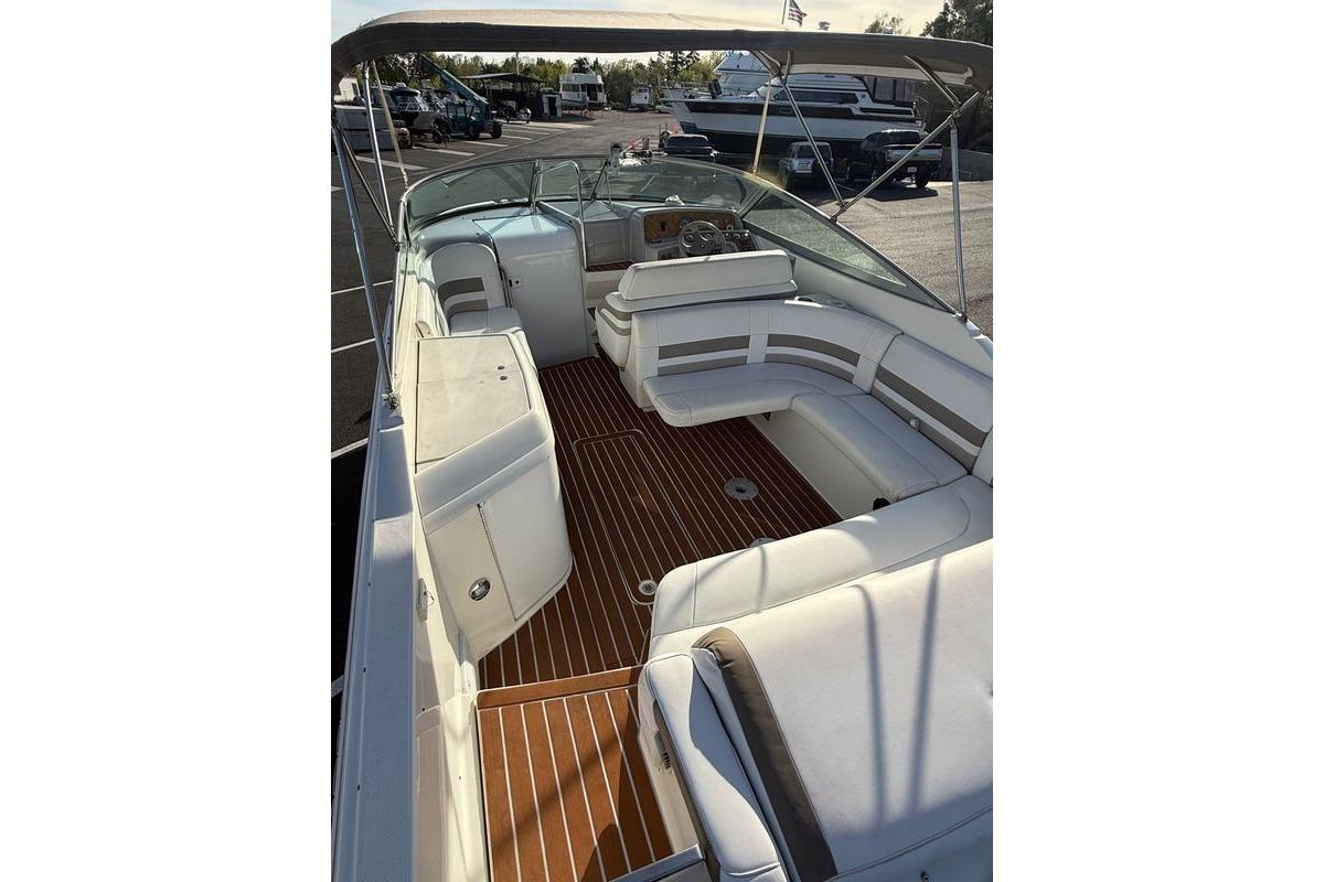 1999 Formula 280 Sun Sport boat interior with white seating and wooden flooring.