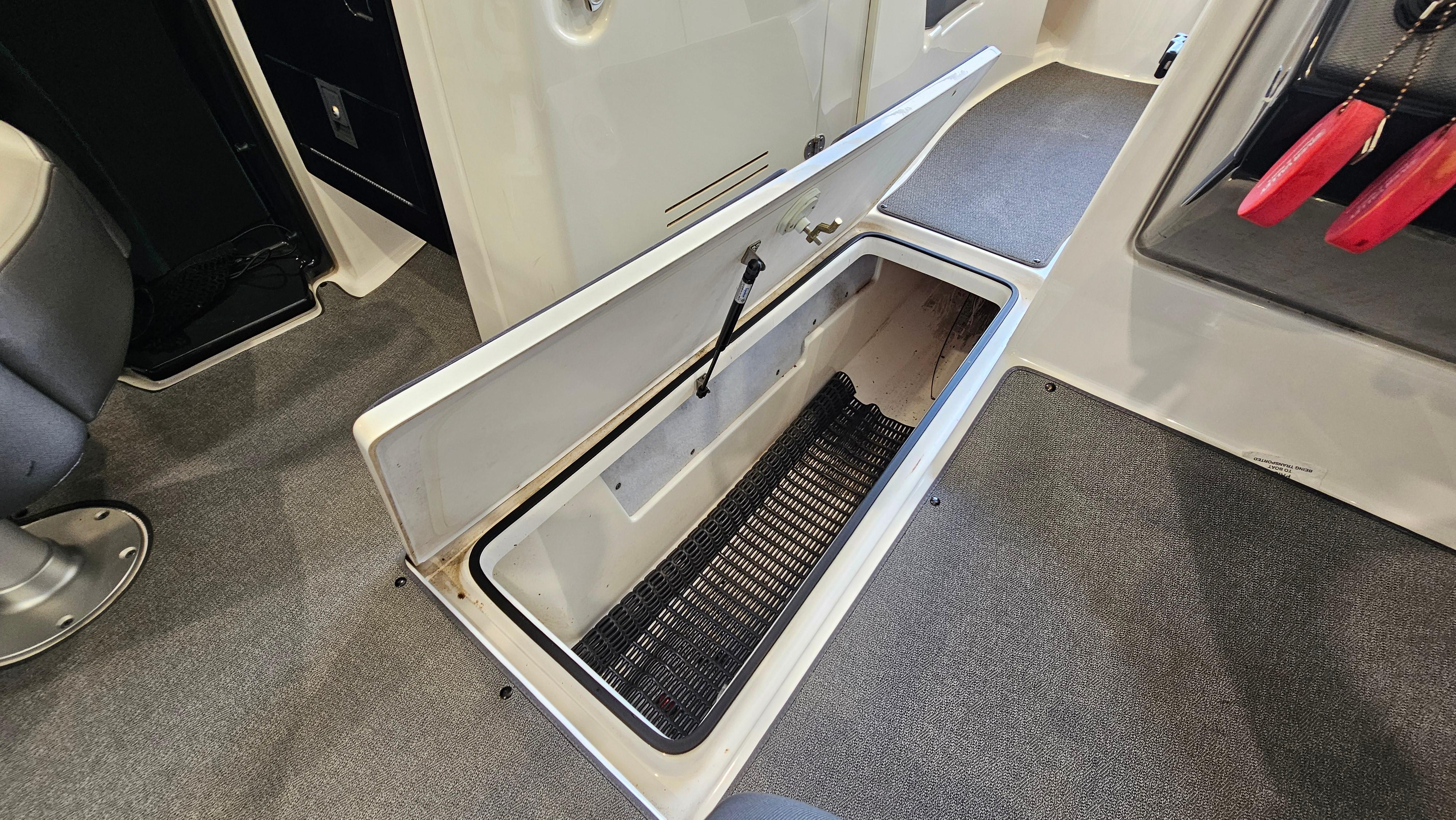 2020 Yamaha SX240 boat interior storage compartment open, showcasing spacious design.