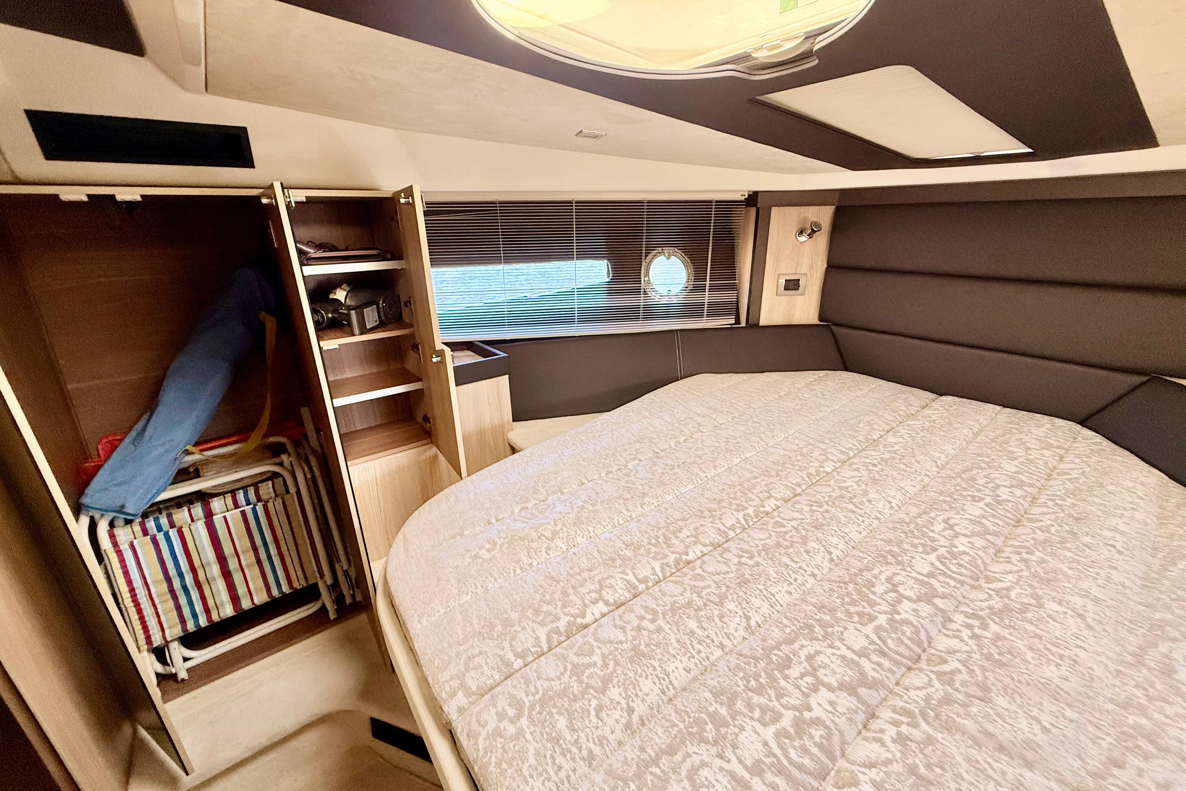 Luxurious cabin interior of 2016 Cranchi M44 HT yacht with bed and storage.