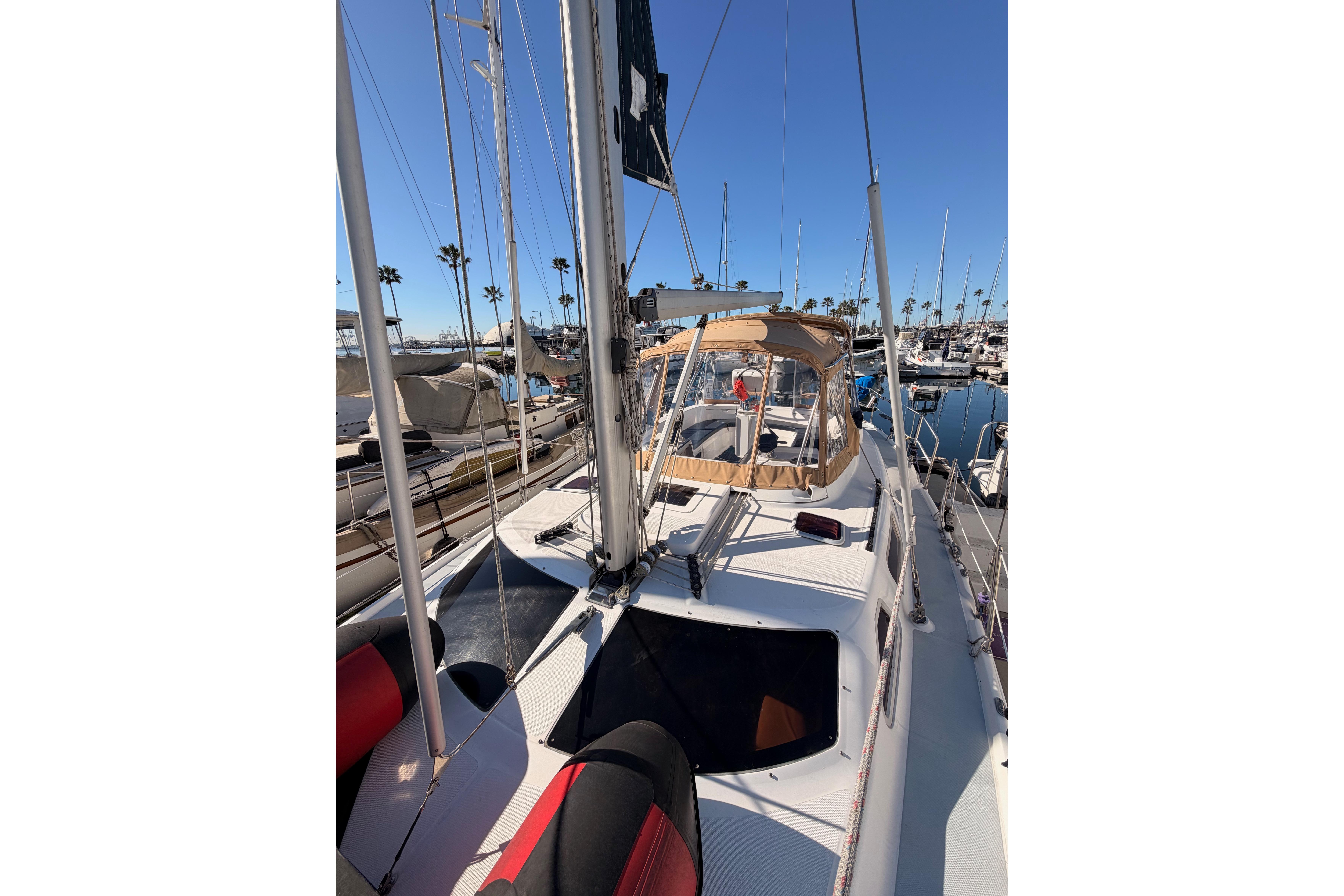2005 Hunter Passage 456 sailboat docked in a sunny marina, showcasing deck and rigging.