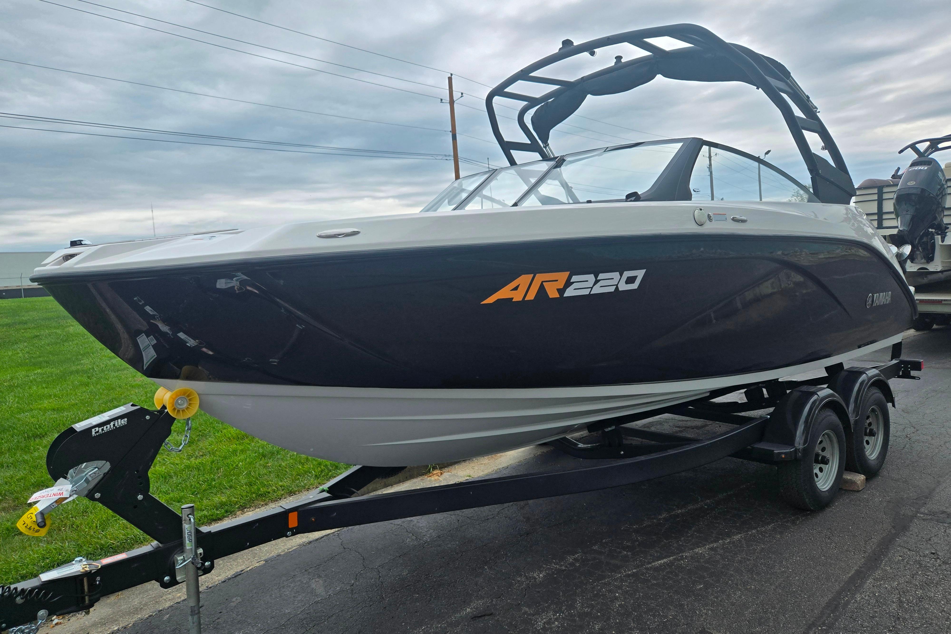 2024 Yamaha Boats AR220 on trailer, sleek design, black and white exterior.