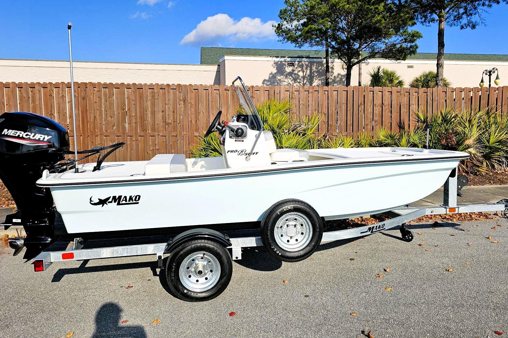 2026 Mako Pro Skiff 13 CC boat on trailer, featuring Mercury outboard motor.