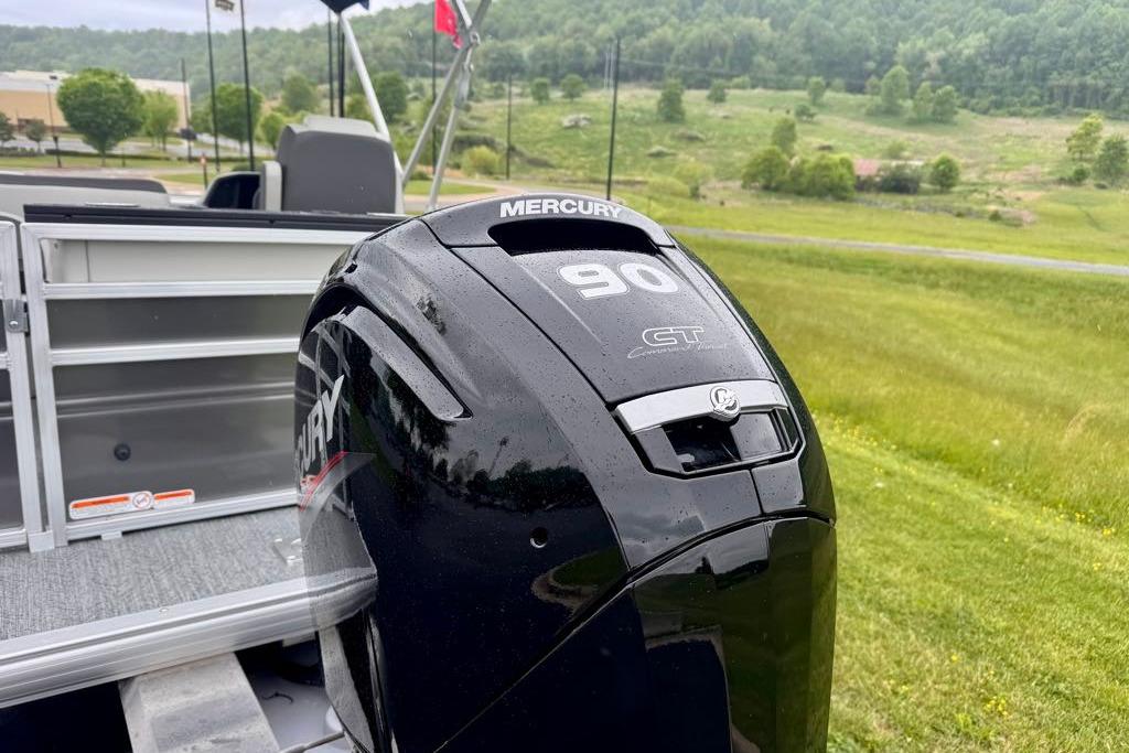 2026 Sun Tracker Fishin' Barge 20 DLX with Mercury 90 GT engine in scenic setting.