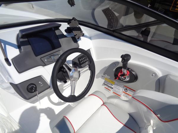 2023 Tahoe 210 Si boat dashboard with steering wheel and control panel.