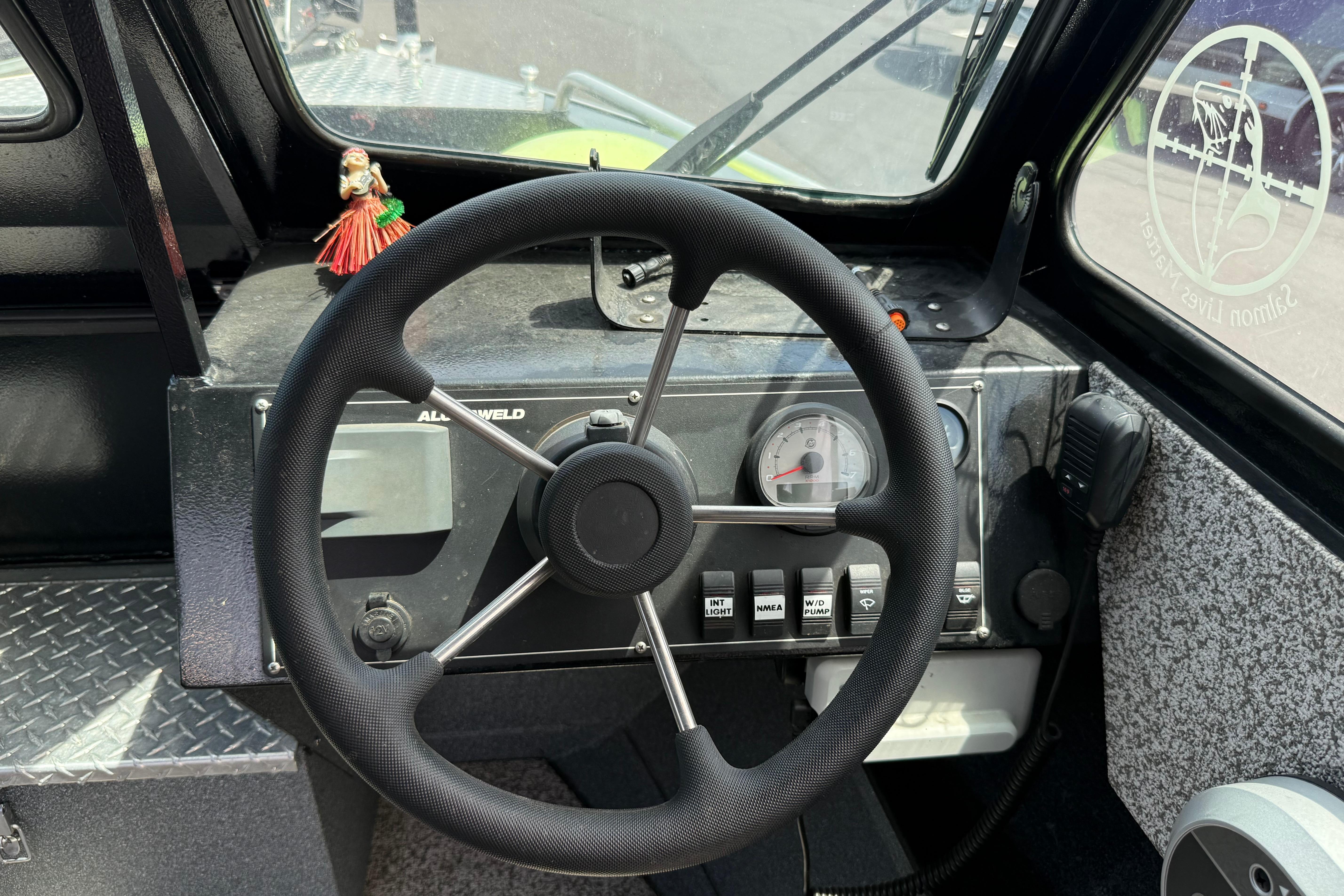 2019 Alumaweld Intruder Hard Top 22' boat dashboard with steering wheel and controls.