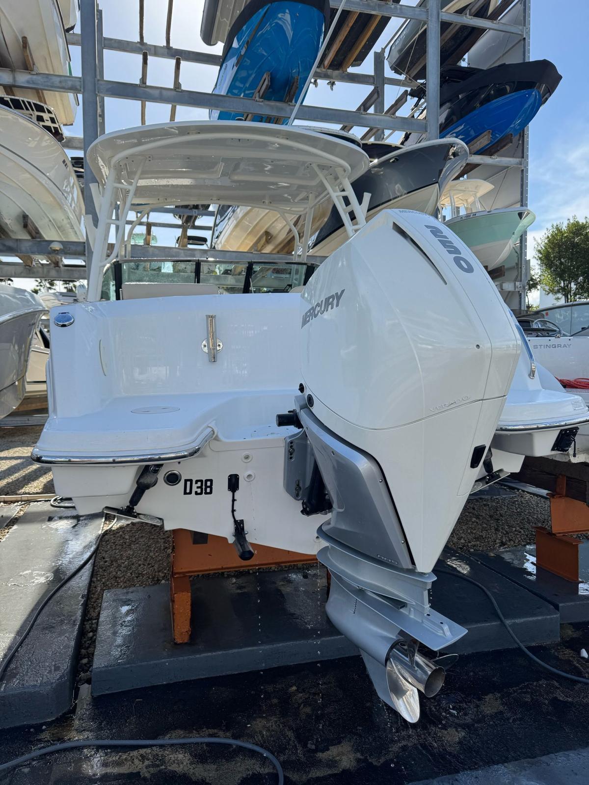 2020 Boston Whaler 230 Vantage boat with Mercury engine, docked in a marina.