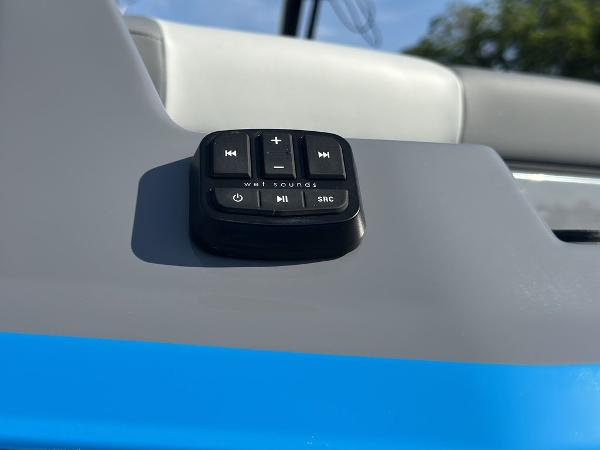 Control panel on 2025 Axis A225 boat dashboard with audio buttons.