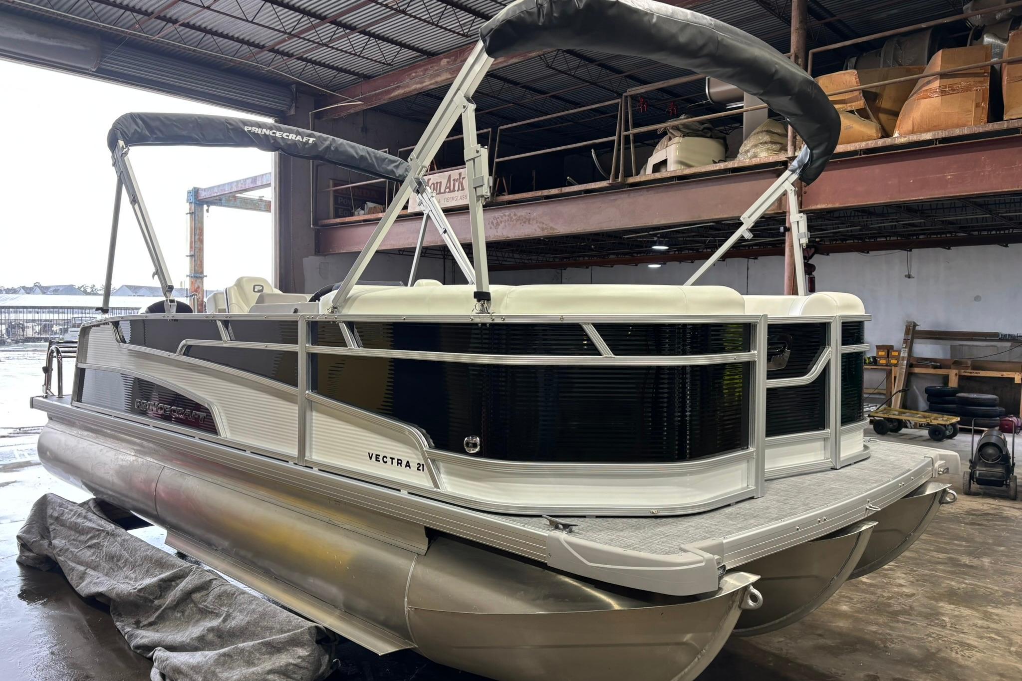 2025 Princecraft Vectra 21 RL pontoon boat in a warehouse setting.