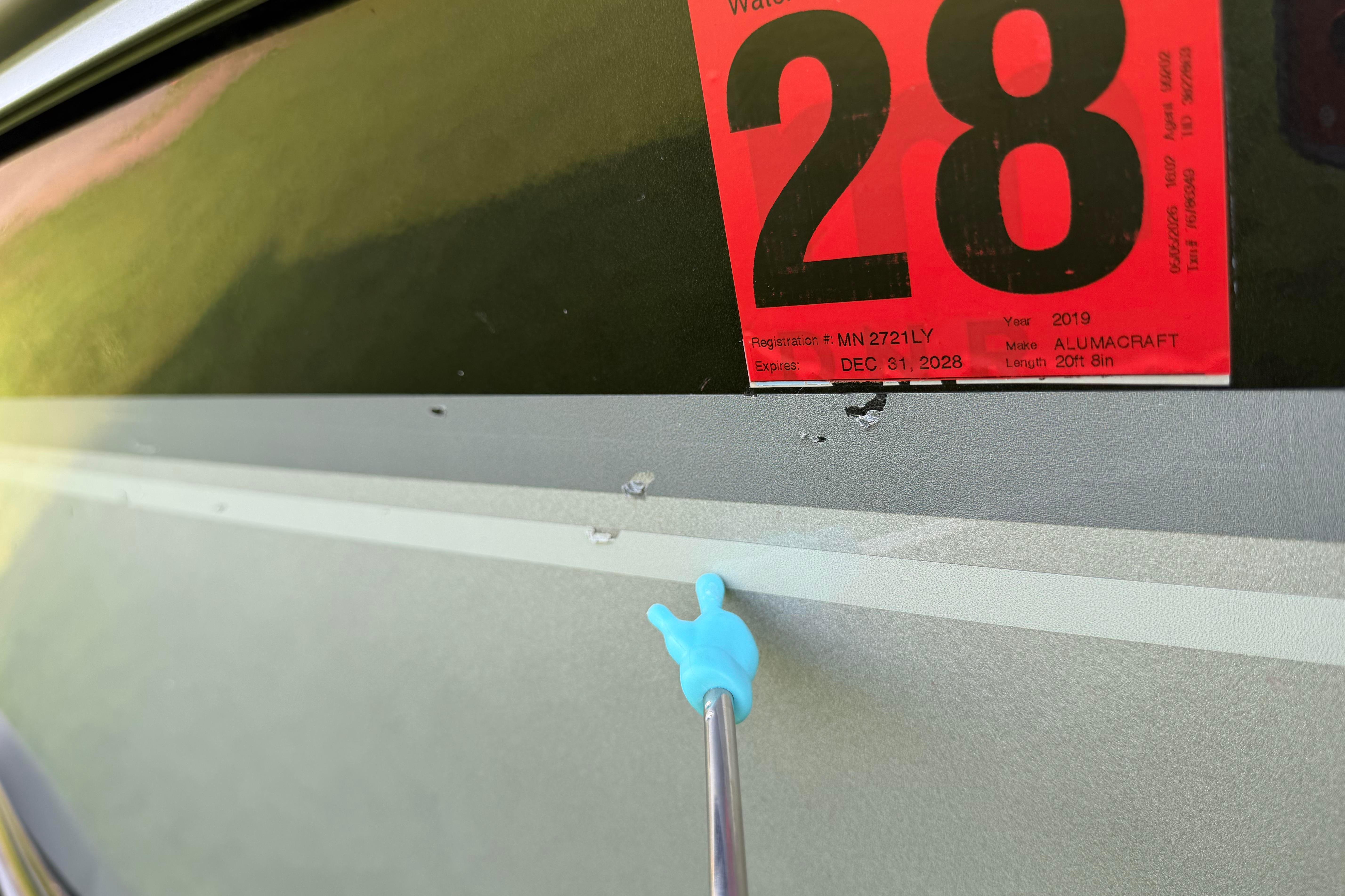 2019 Alumacraft Trophy 205 boat with registration sticker and minor hull damage.