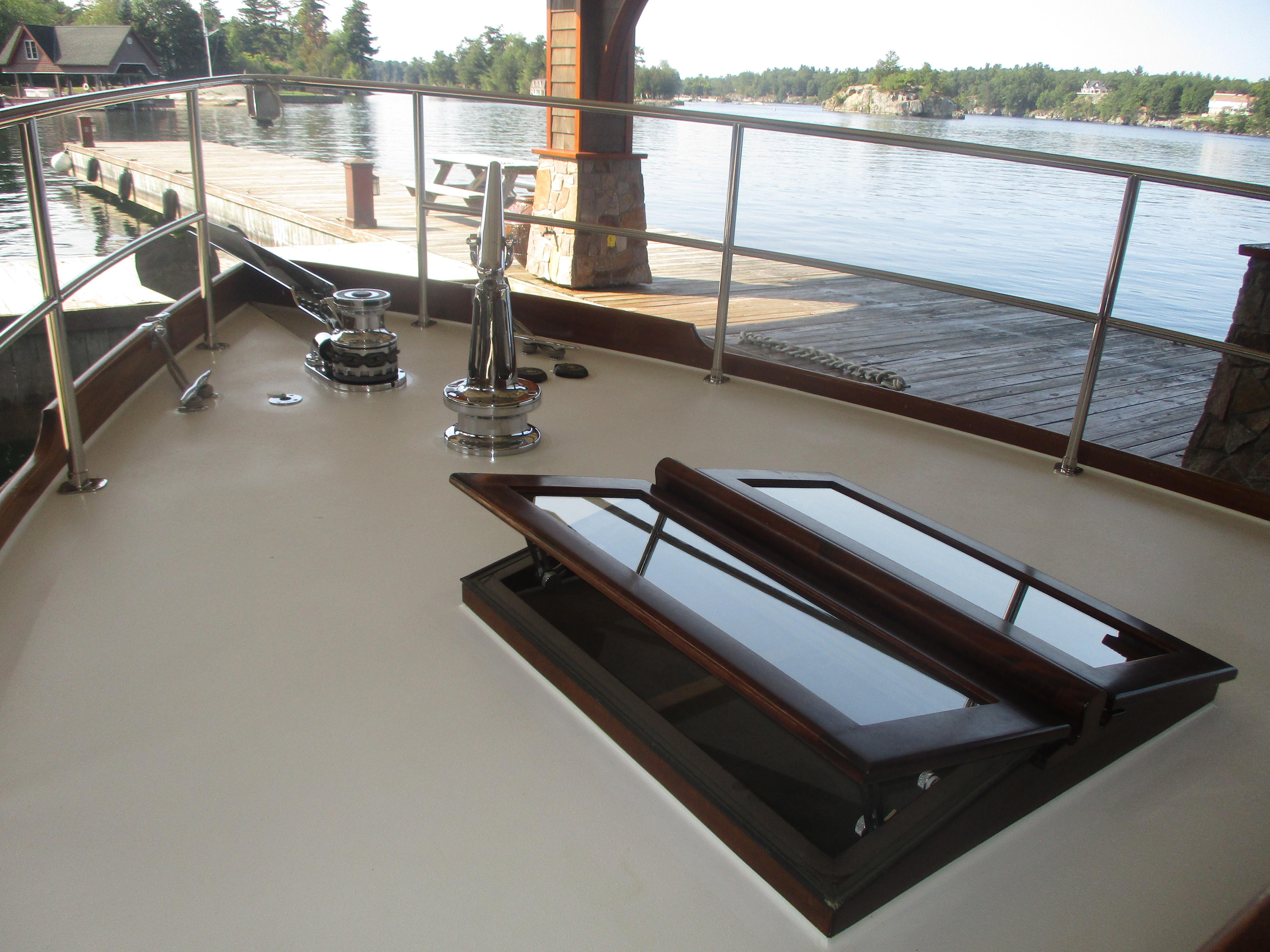 Vintage 1929 Gidley 52 Retro Modern Motor Yacht deck with scenic waterfront view.