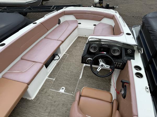 2017 Glastron 205 boat interior with beige seating and steering console.