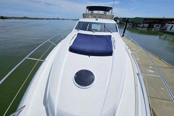 2005 Sunseeker Manhattan 66 yacht docked, featuring sleek design and spacious deck.