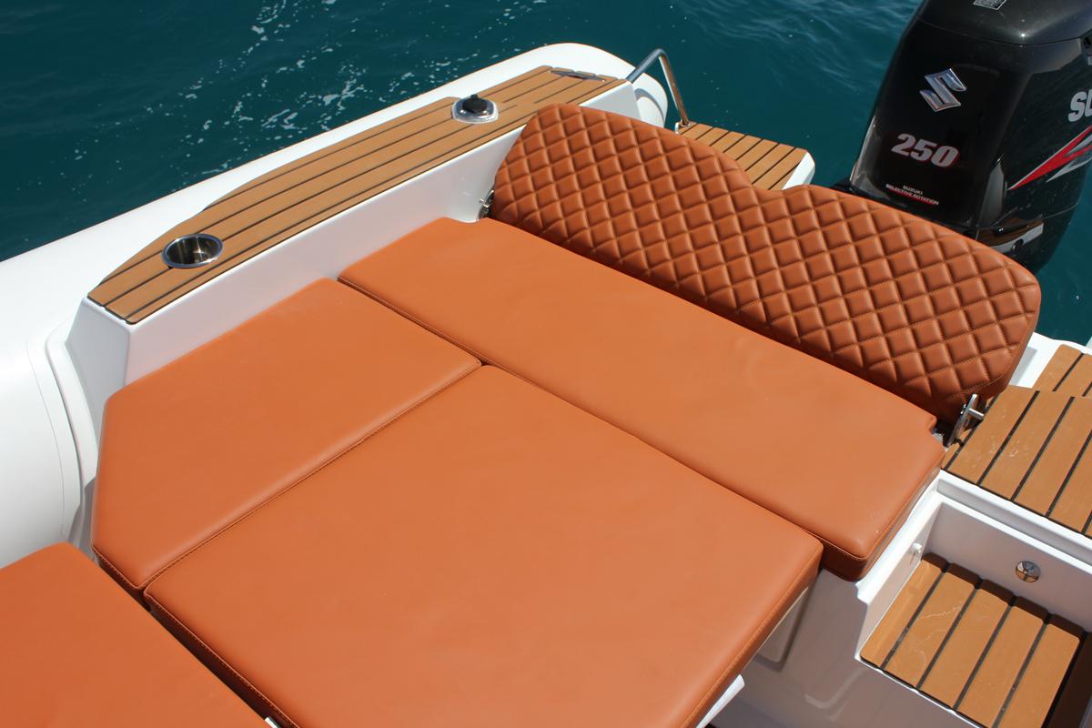 Luxurious seating on 2025 Tiger Marine 740 PL boat with quilted upholstery and wooden accents.