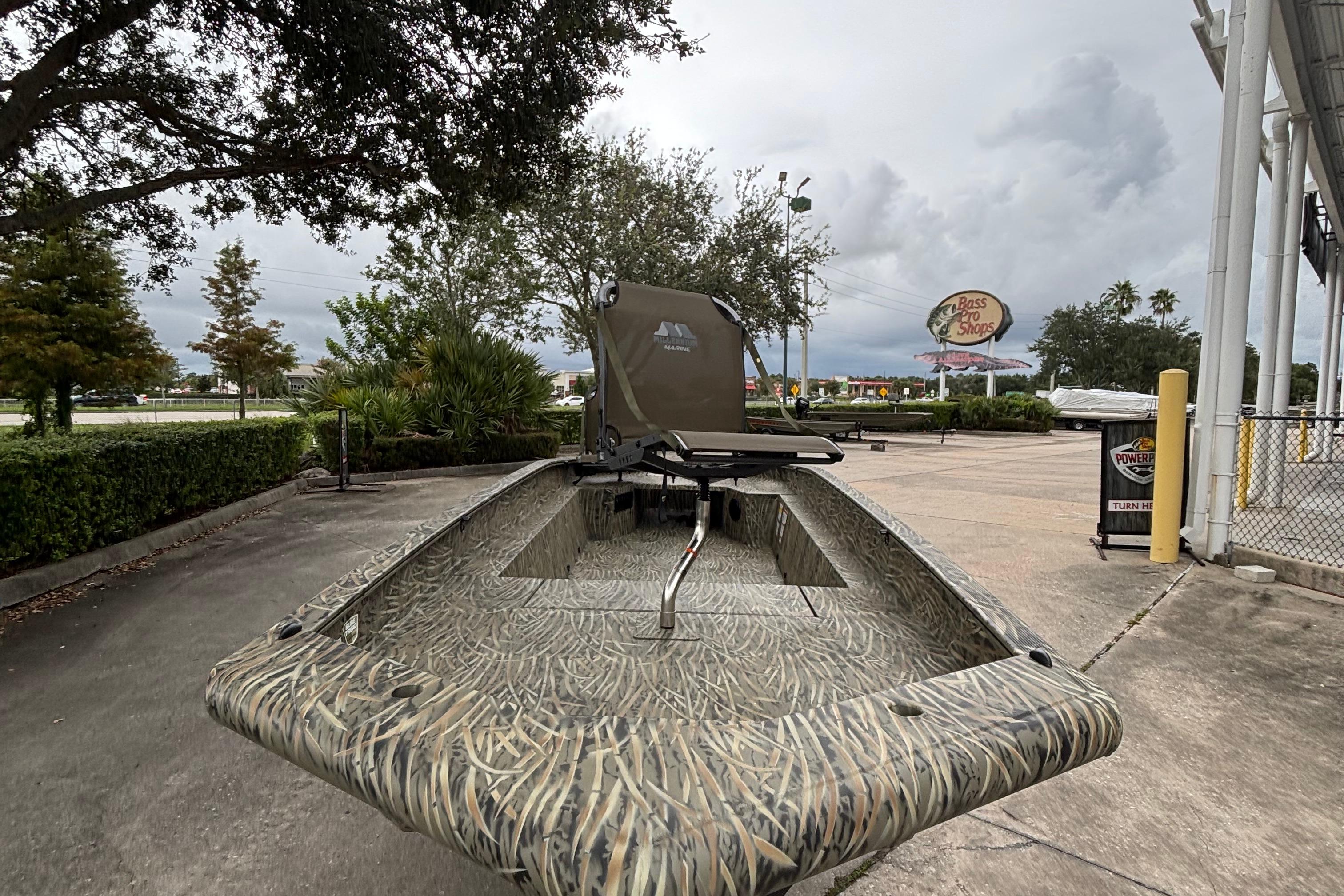 2026 Tracker Grizzly 1650 T Prairie Wings Edition boat in a parking lot, camo design.