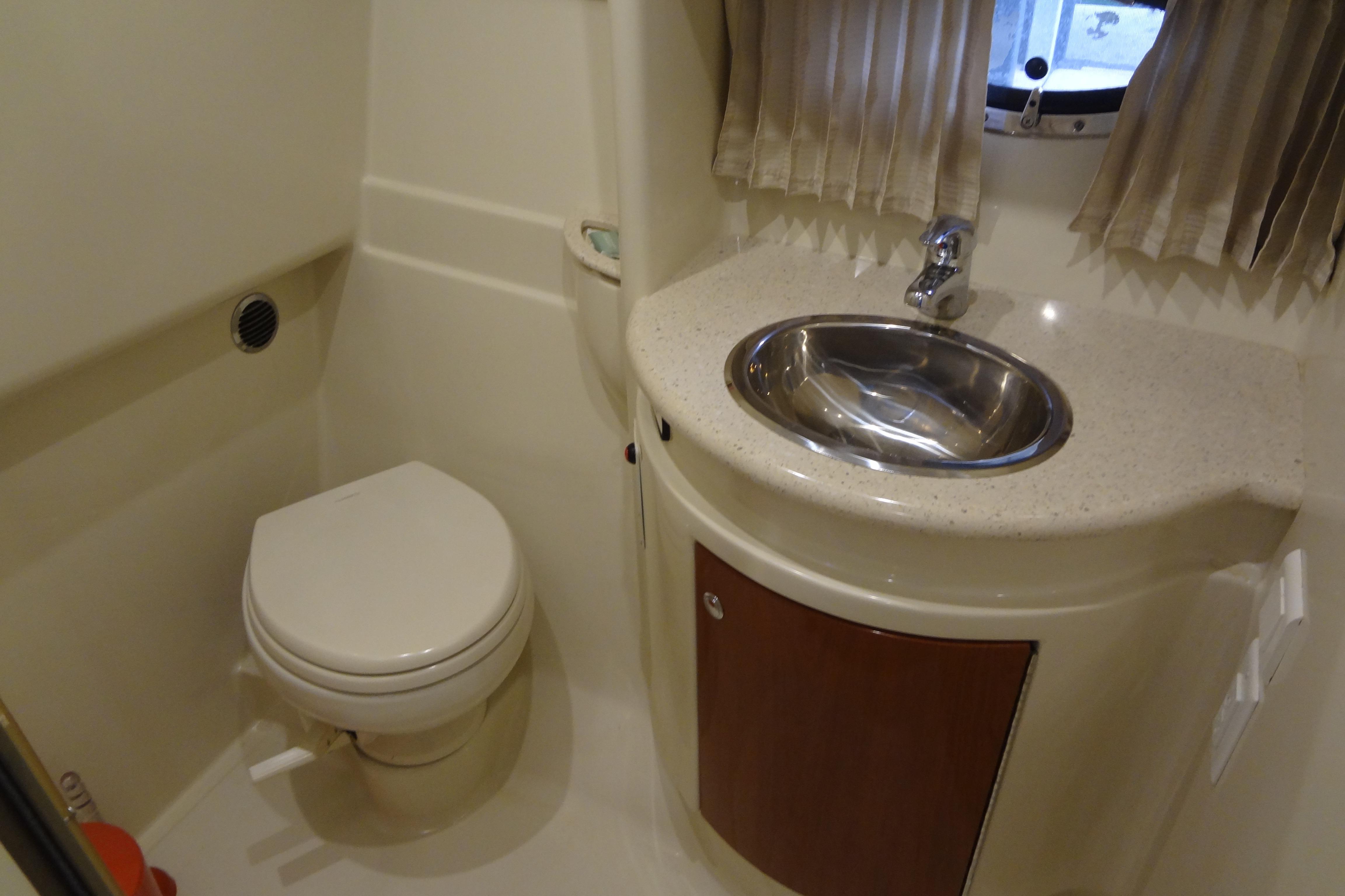 2007 Formula 34 Performance Cruiser bathroom with toilet, sink, and window.