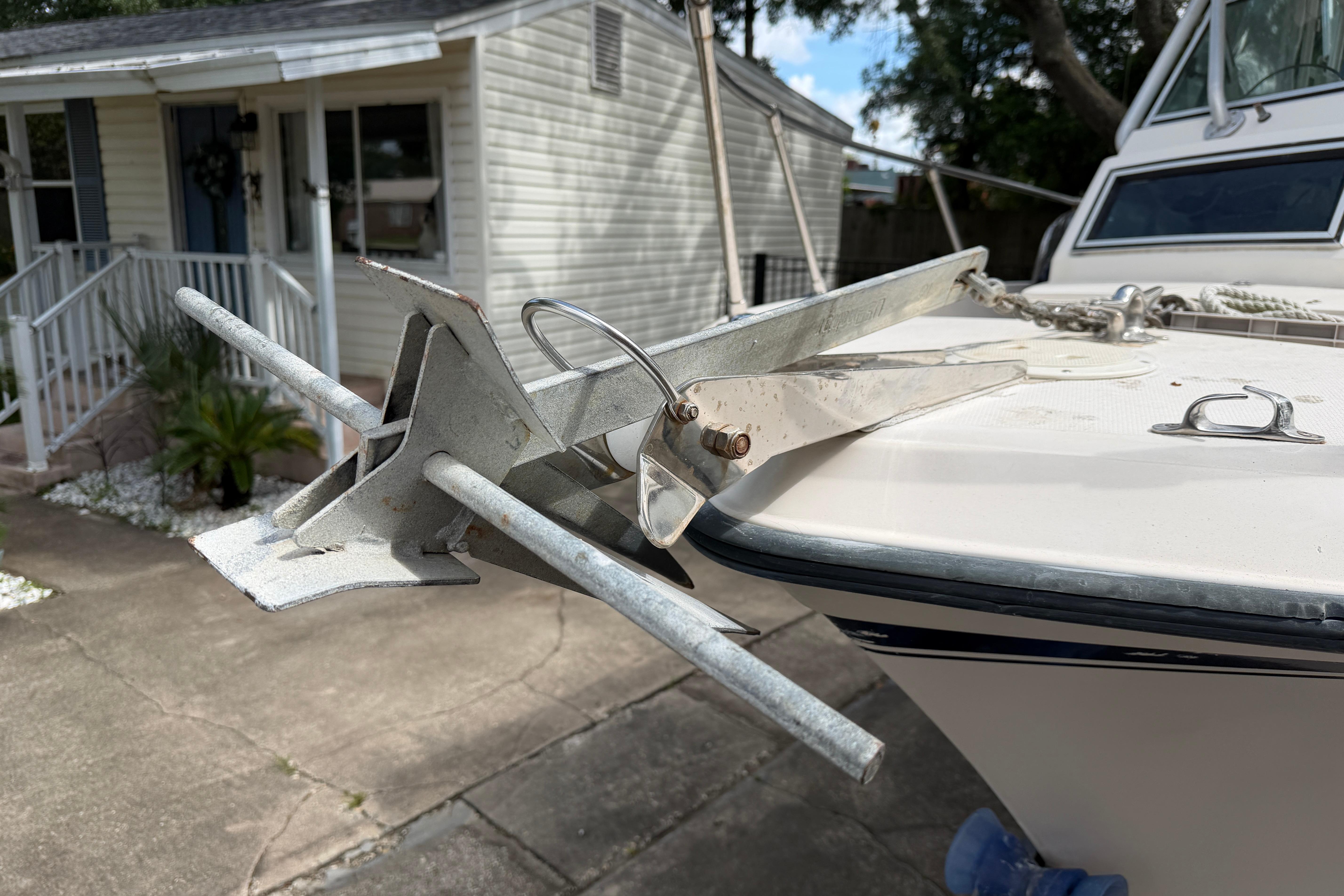 1987 Grady-White Seafarer 226 boat with anchor, parked near a house.