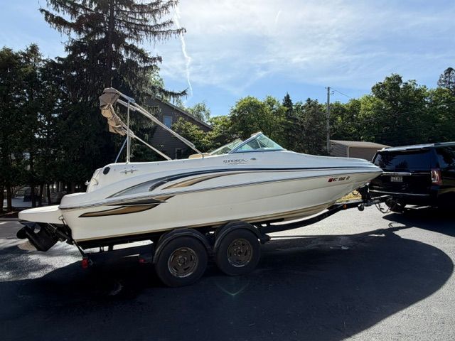 A white 2001 Sea Ray 210 Sundeck boat on a trailer, ready for transport.