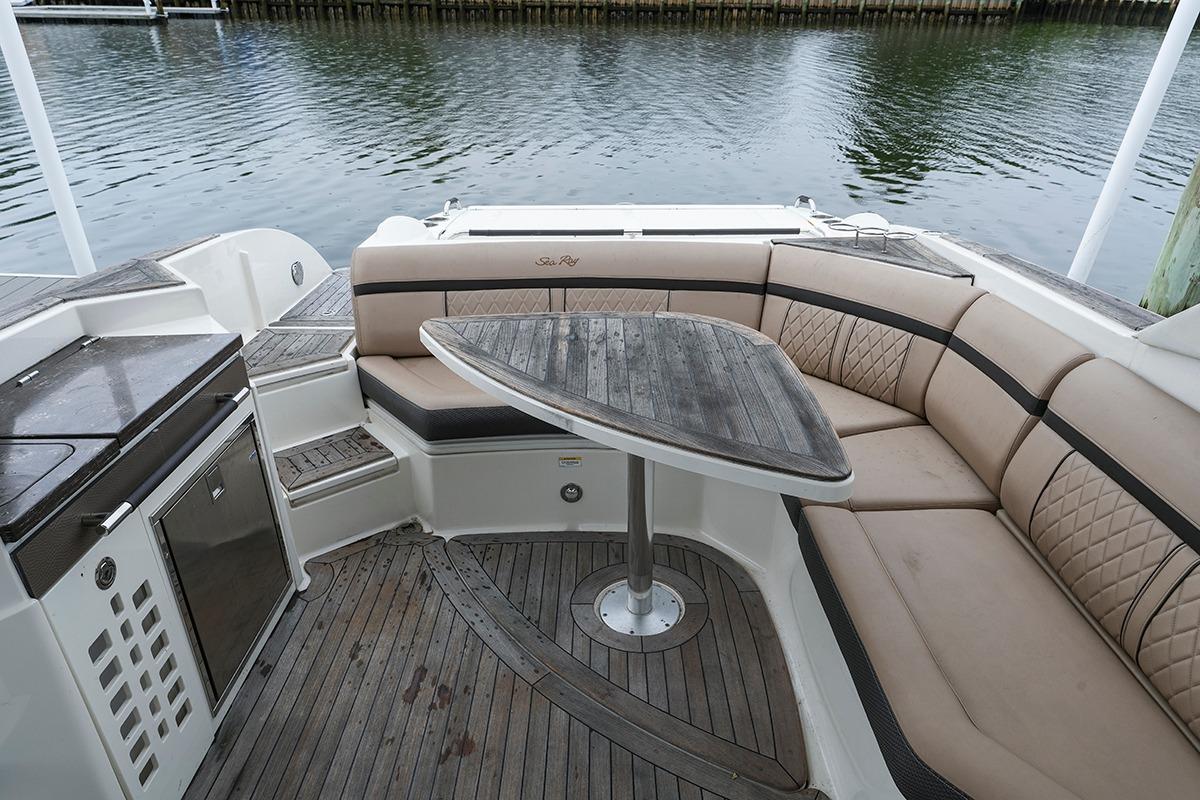 Luxurious 2018 Sea Ray SLX 350 boat interior with elegant seating and wooden table.