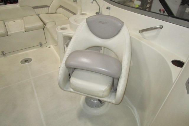 2004 Stingray 240 LR boat interior with swivel captain's chair and seating area.