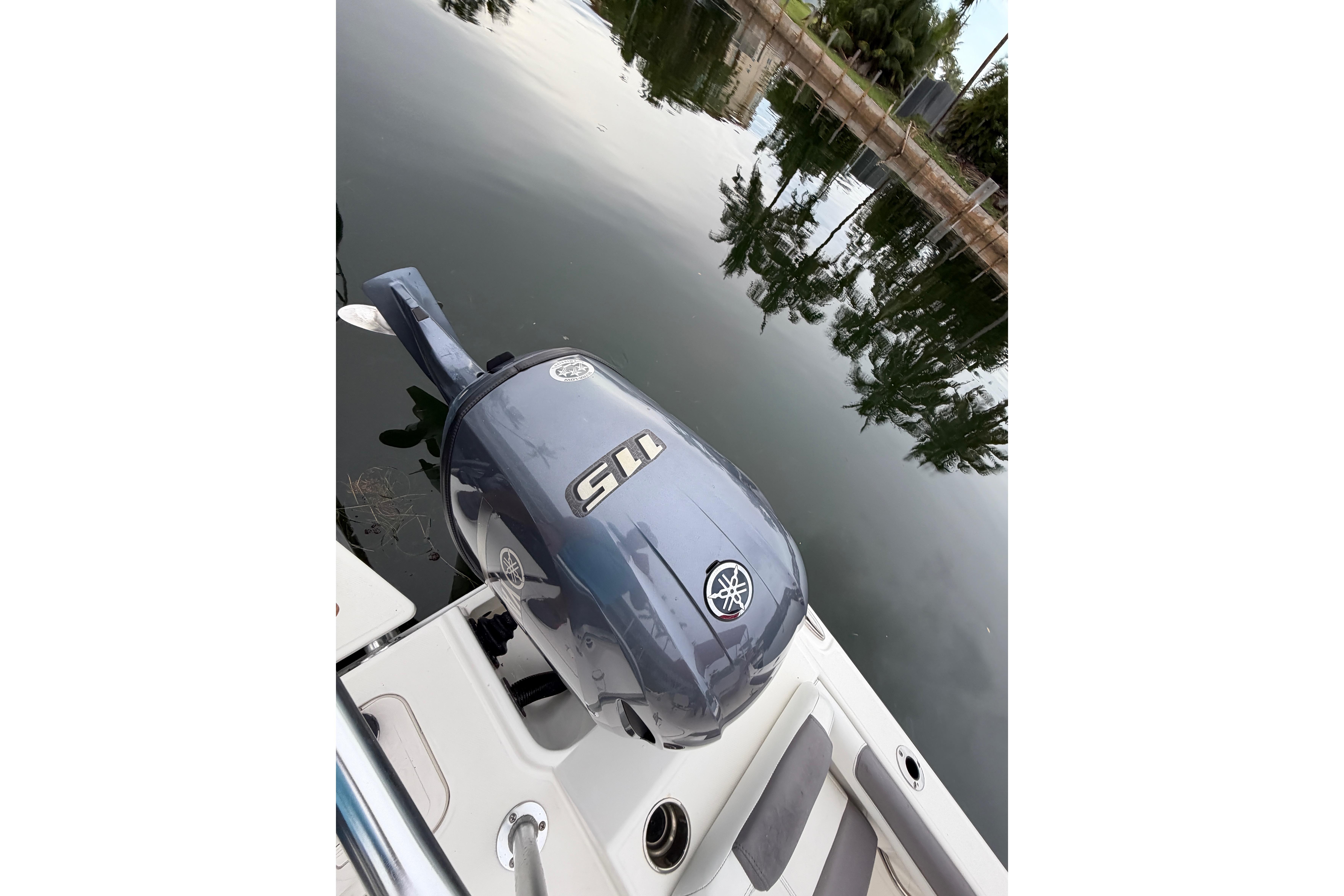 2019 World Cat 230 DC boat with Yamaha 115 outboard motor on calm water.