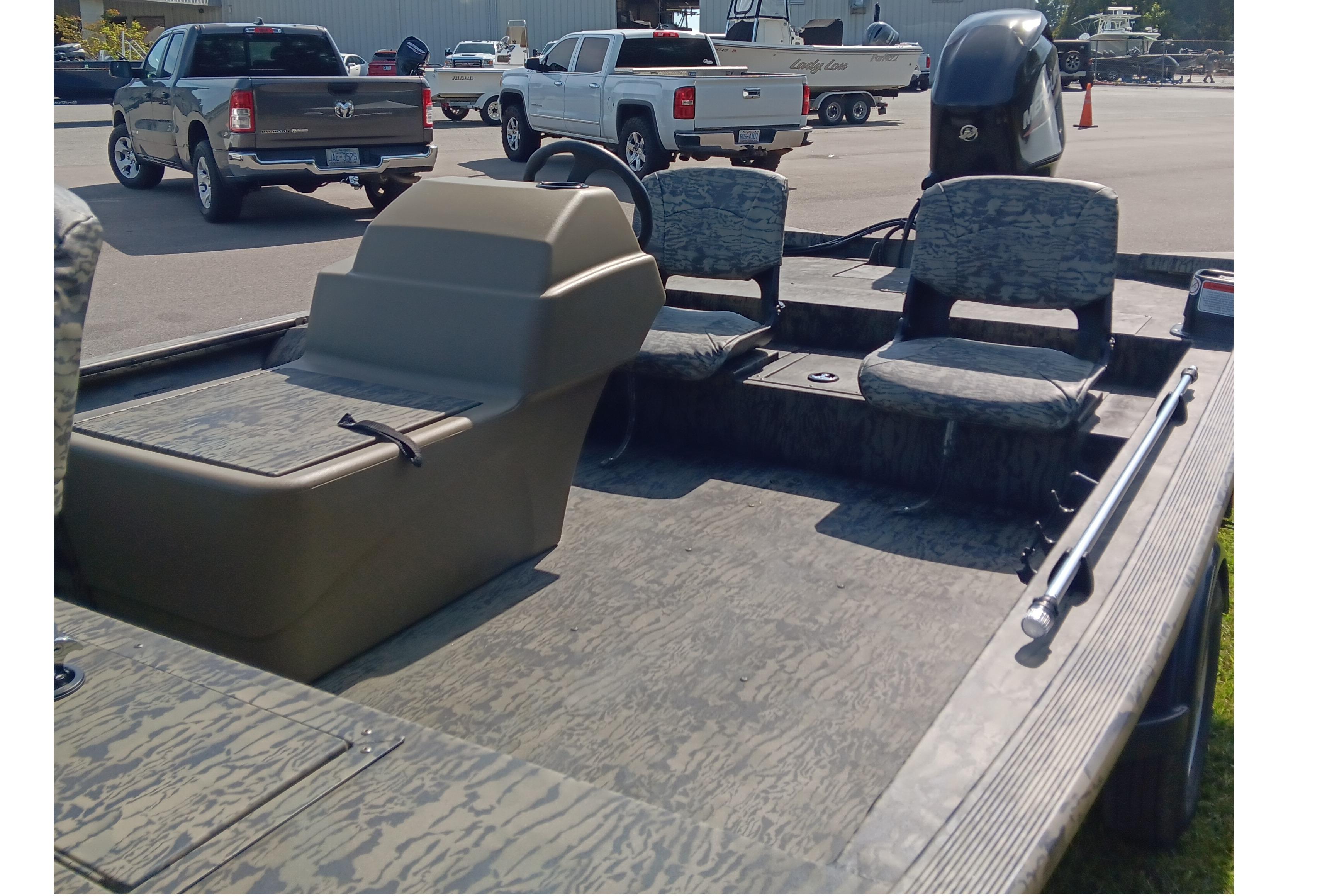 2026 Tracker Grizzly 1754 SC boat interior with camouflage seating and steering console.