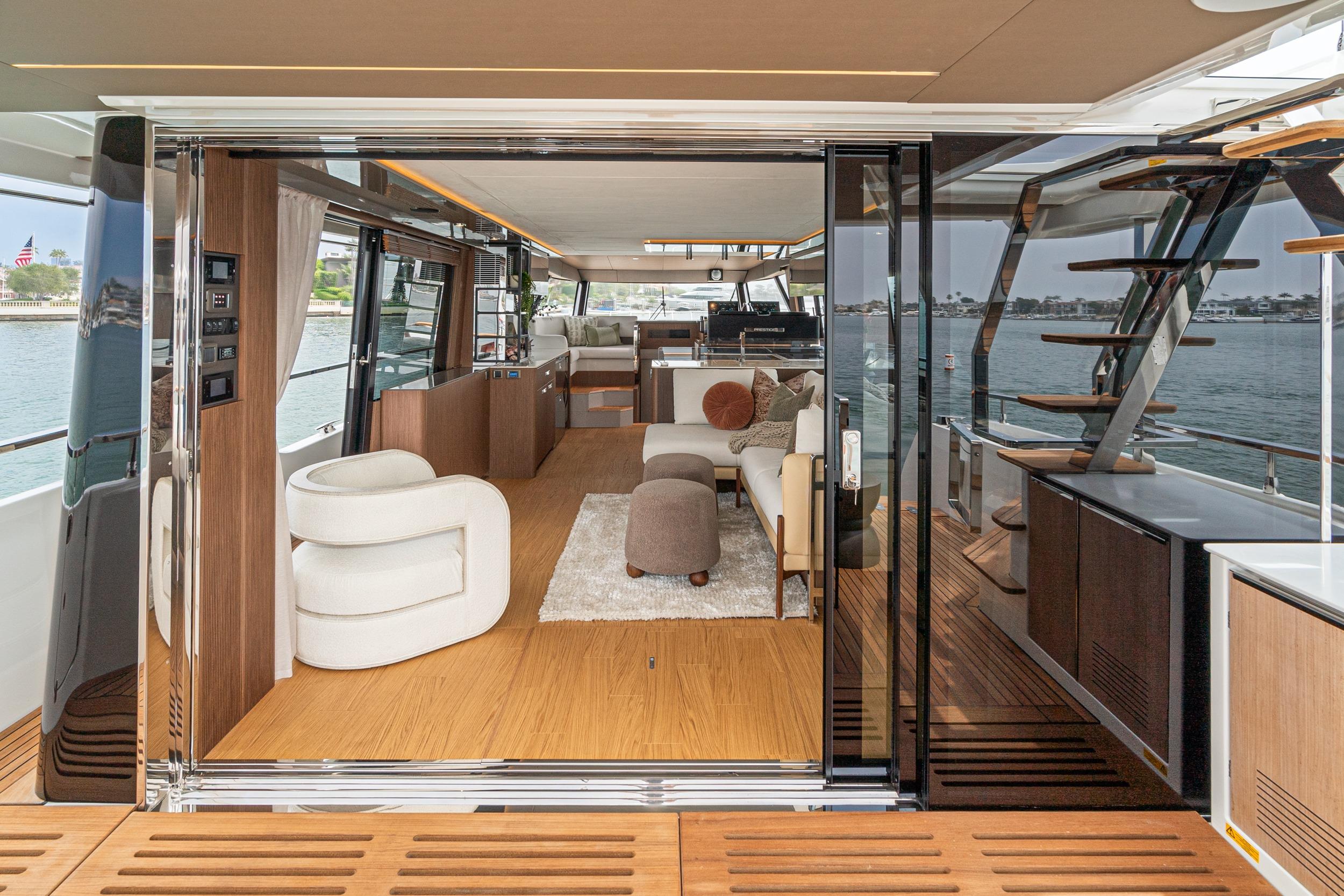 Luxurious interior of 2024 Prestige X60 yacht with modern furnishings and scenic water view.