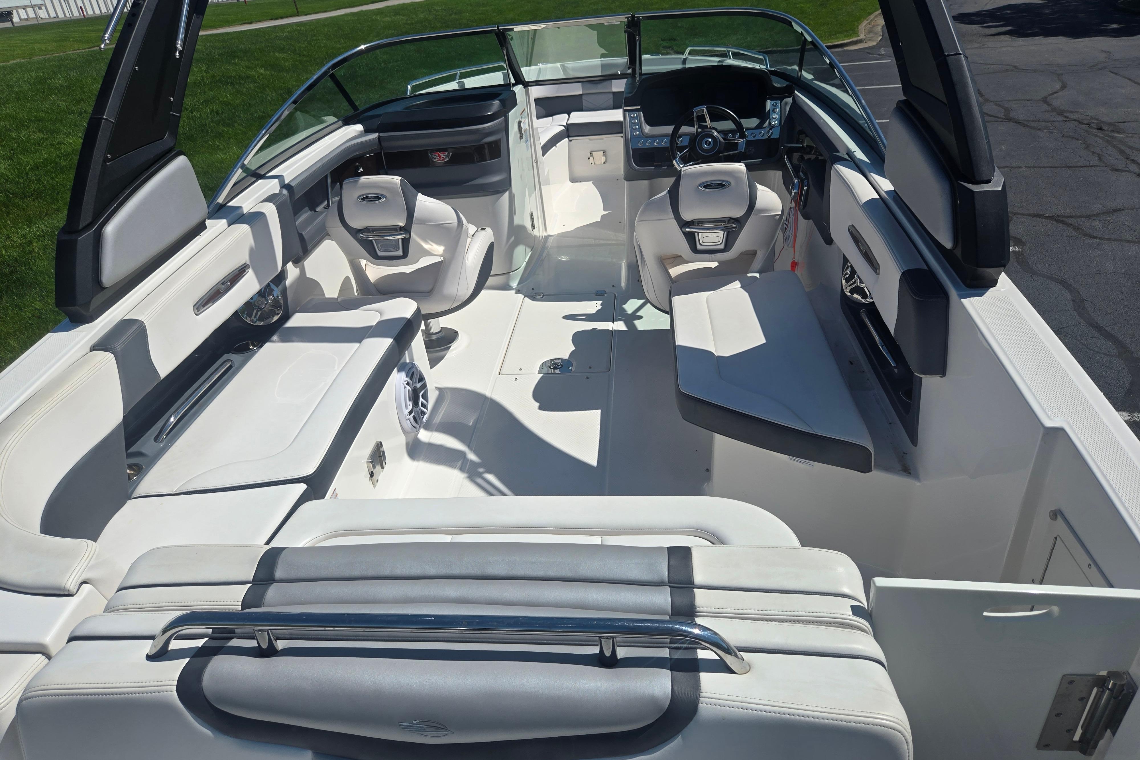 2018 Chaparral 267 SSX boat interior with white seating and modern dashboard.