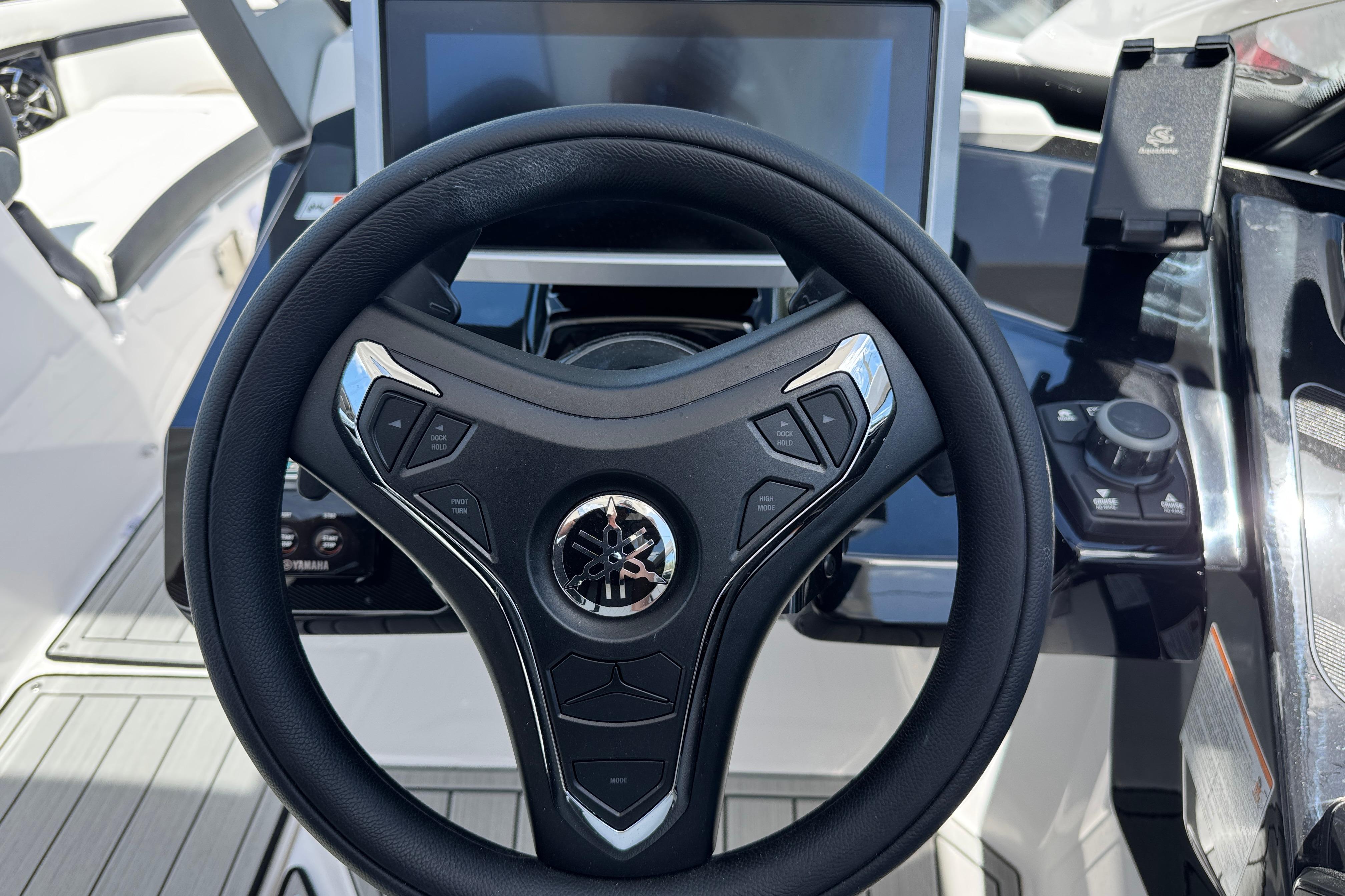 Steering wheel and dashboard of 2026 Yamaha Boats 275SD, featuring modern controls and display.