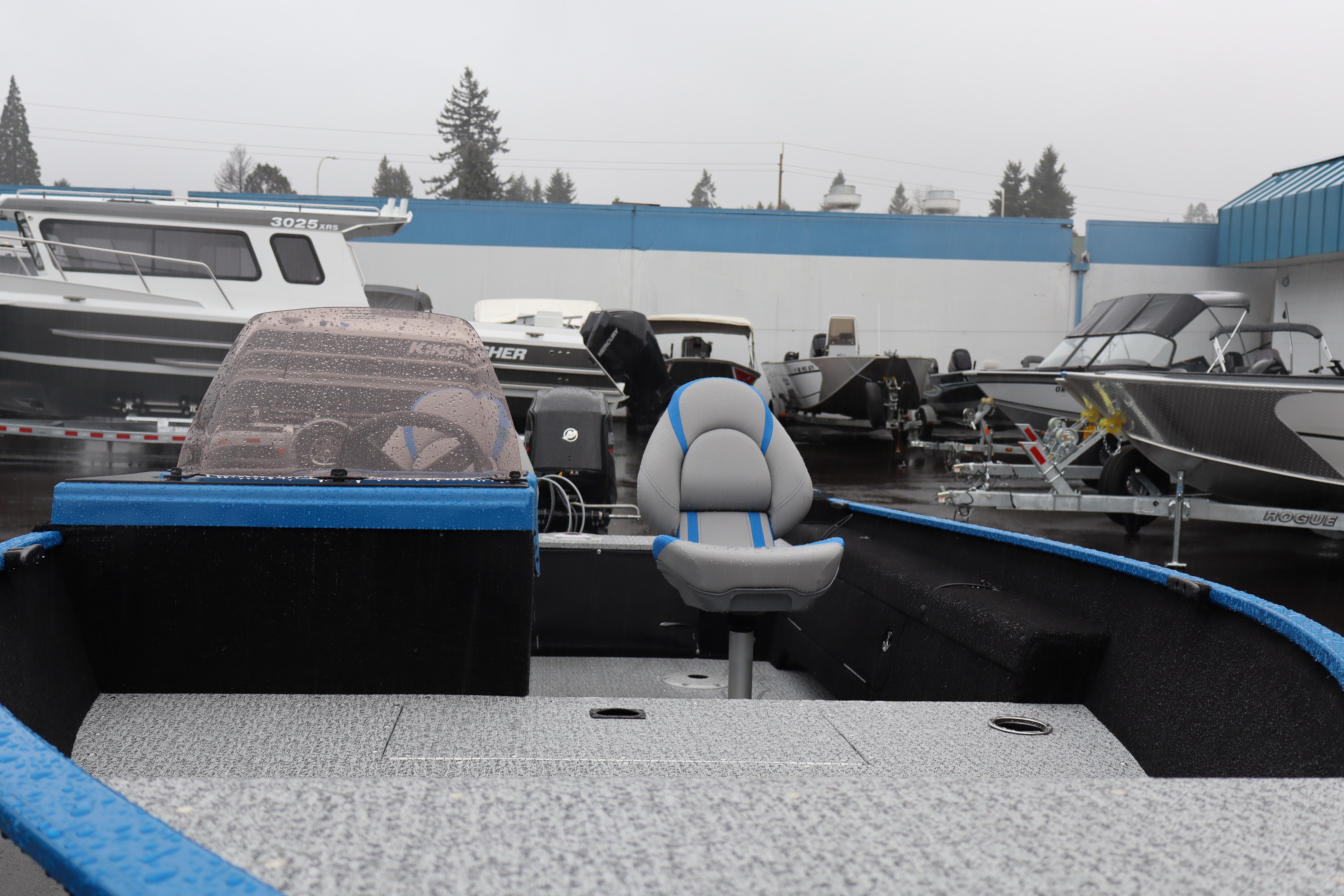 2026 Smoker Craft Lazer 161 boat in showroom, featuring sleek design and comfortable seating.