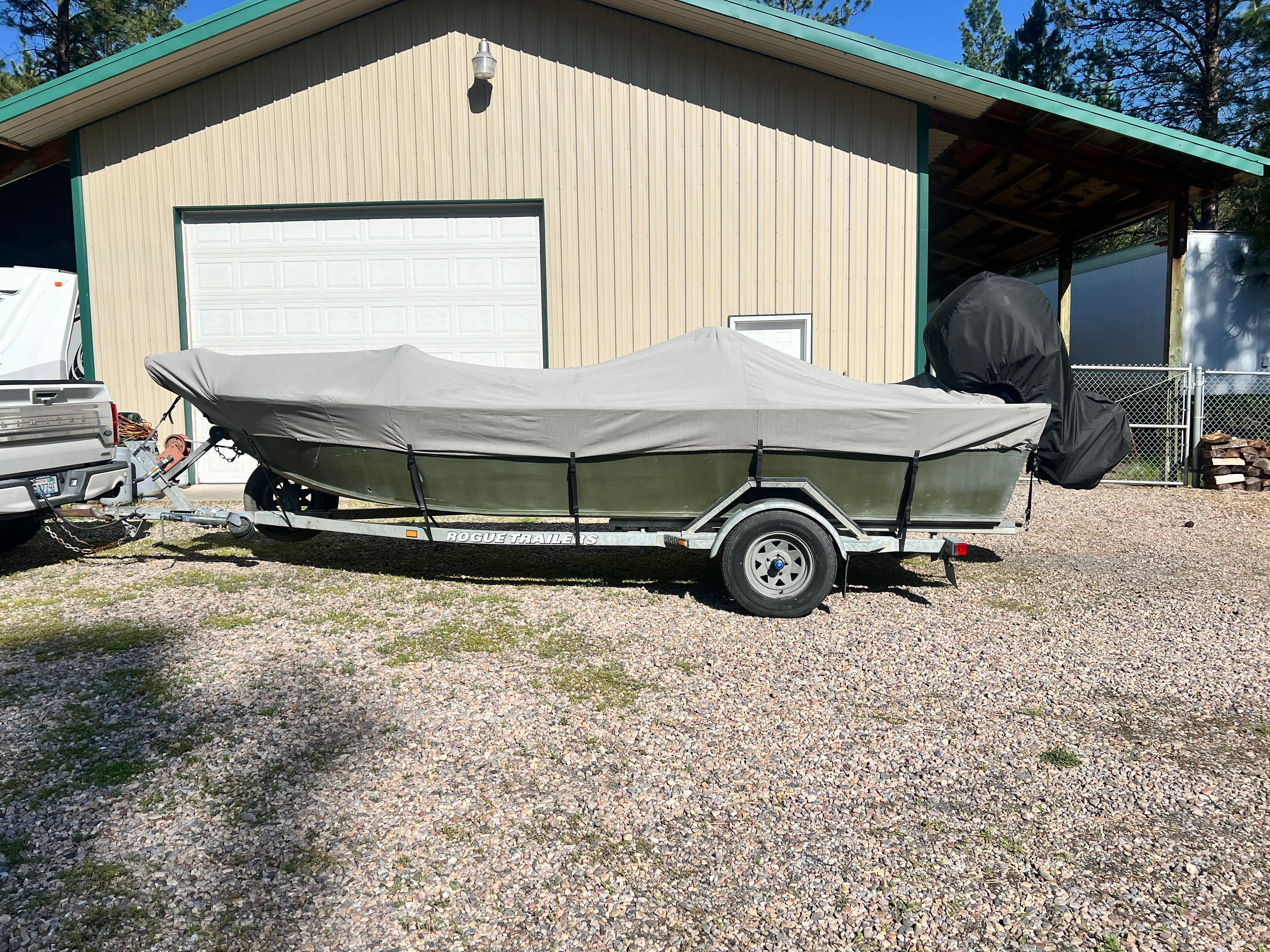 2002 Alumaweld Super Vee boat with cover on trailer.