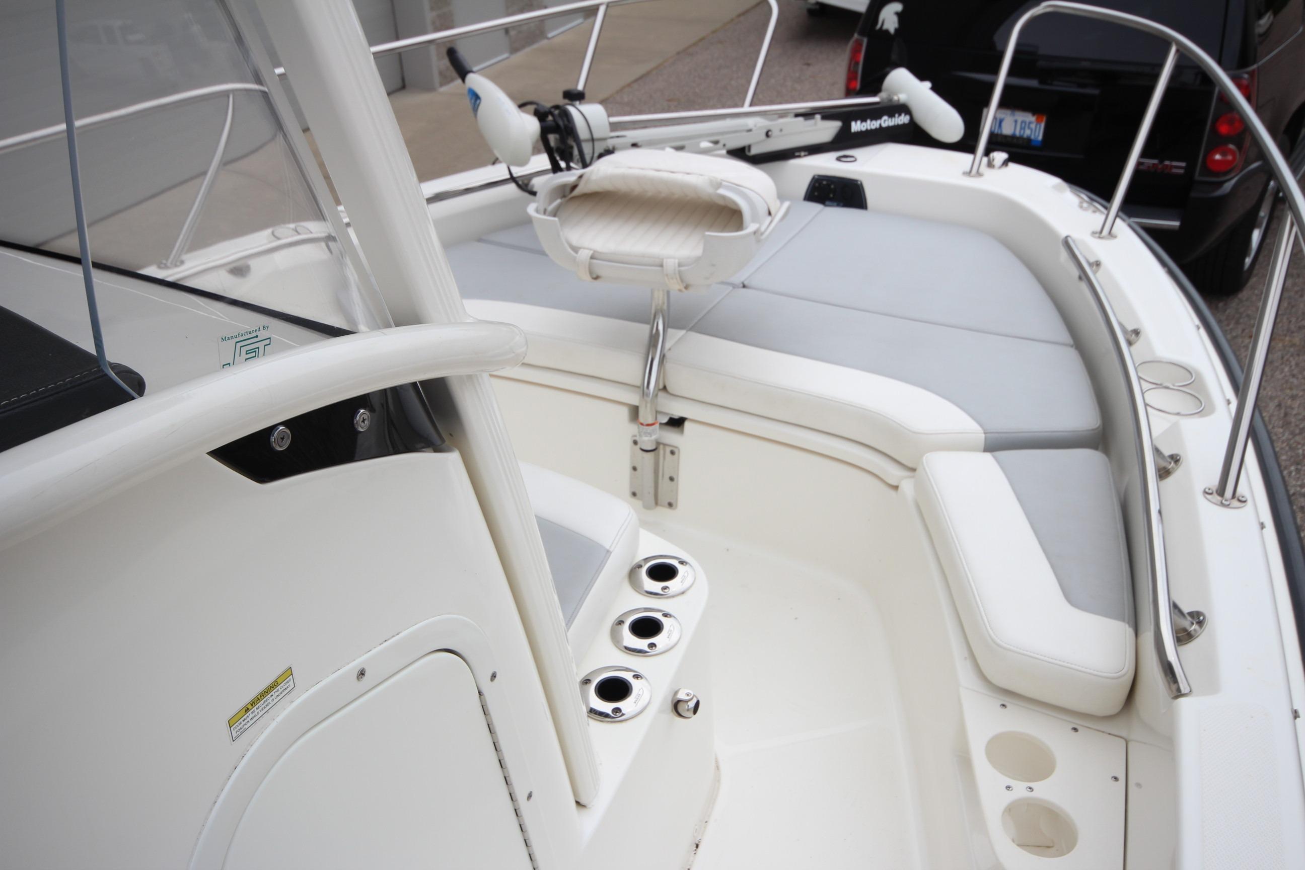 2014 Boston Whaler 210 Dauntless boat interior with seating and fishing rod holders.
