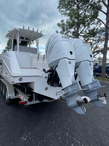 2014 Everglades 325 Center Console boat with dual outboard engines on a trailer.