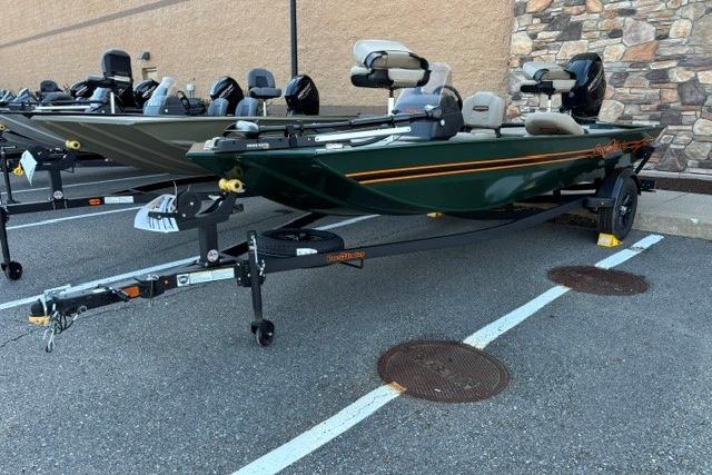 2026 Tracker Bass Tracker Classic Limited boat on trailer in parking lot.