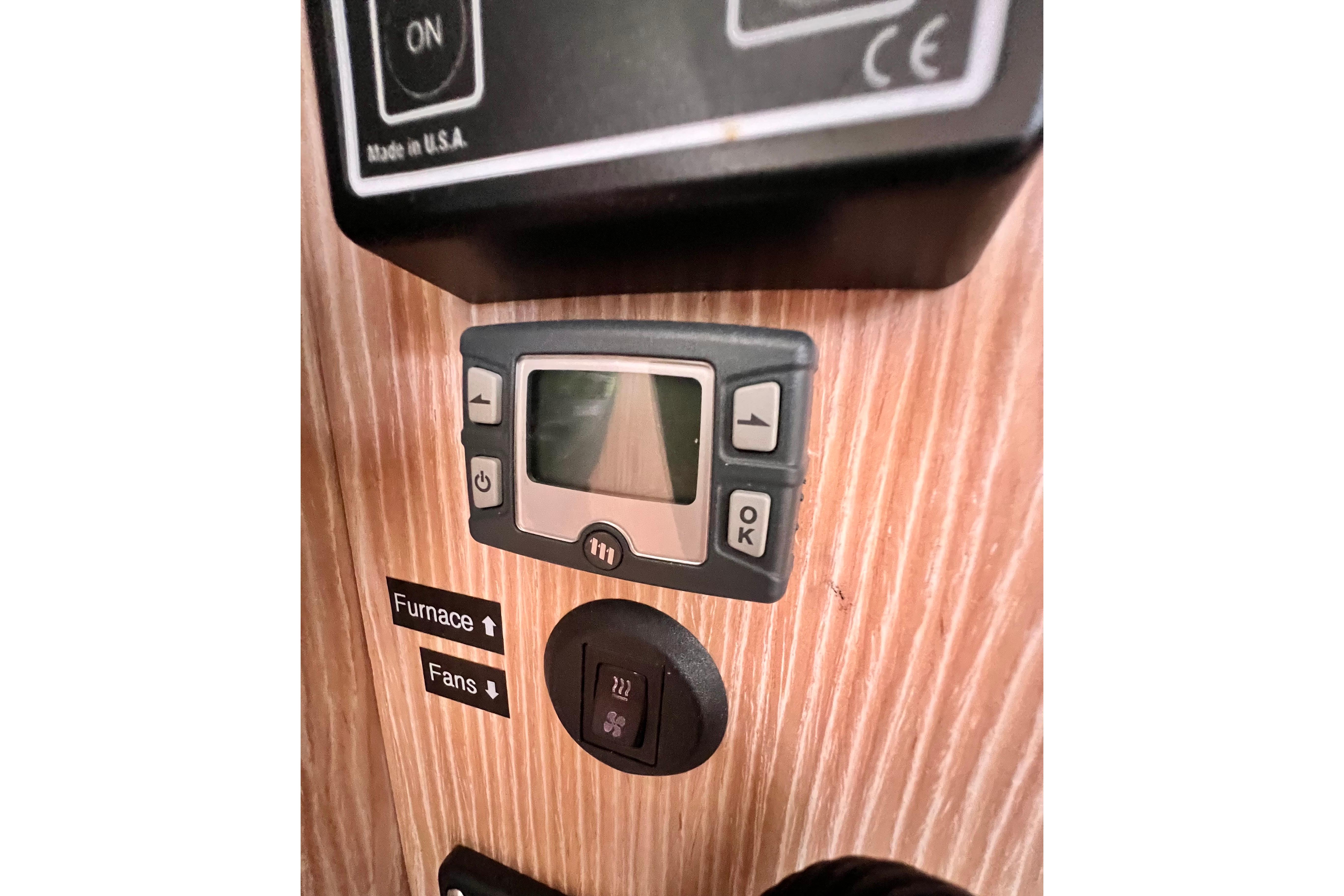 Control panel on a 2016 Hanse 455 yacht, featuring furnace and fan switches.