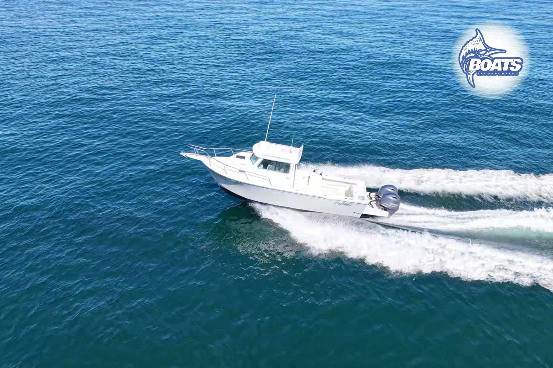 2021 Parker 2520 XLD Sport Cabin boat cruising on open blue water.