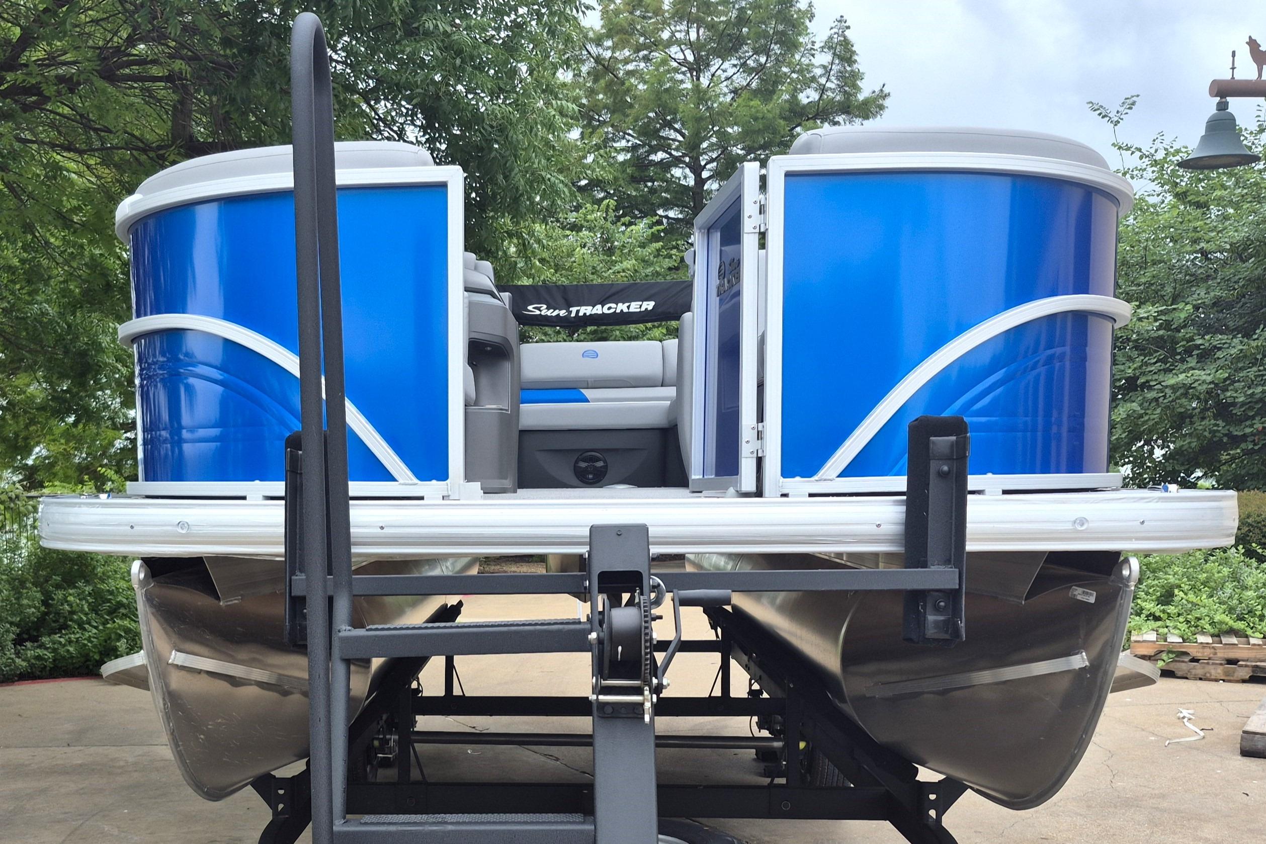 2026 Sun Tracker Party Barge 20 DLX pontoon boat with vibrant blue exterior.