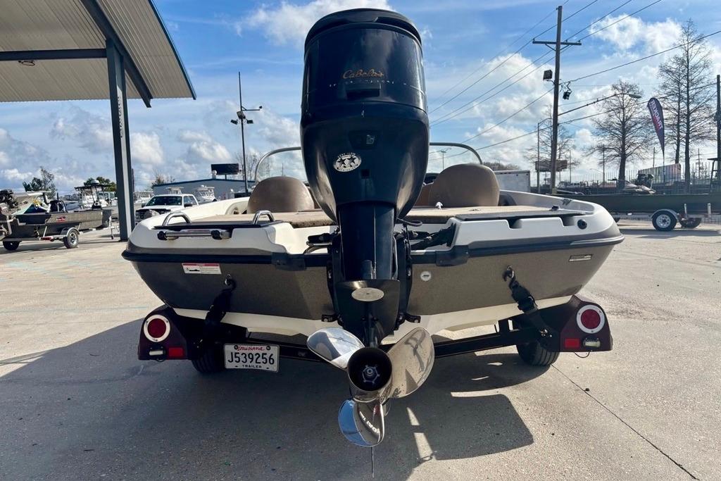 2008 Ranger 180 Reata boat with outboard motor, parked outdoors on a sunny day.