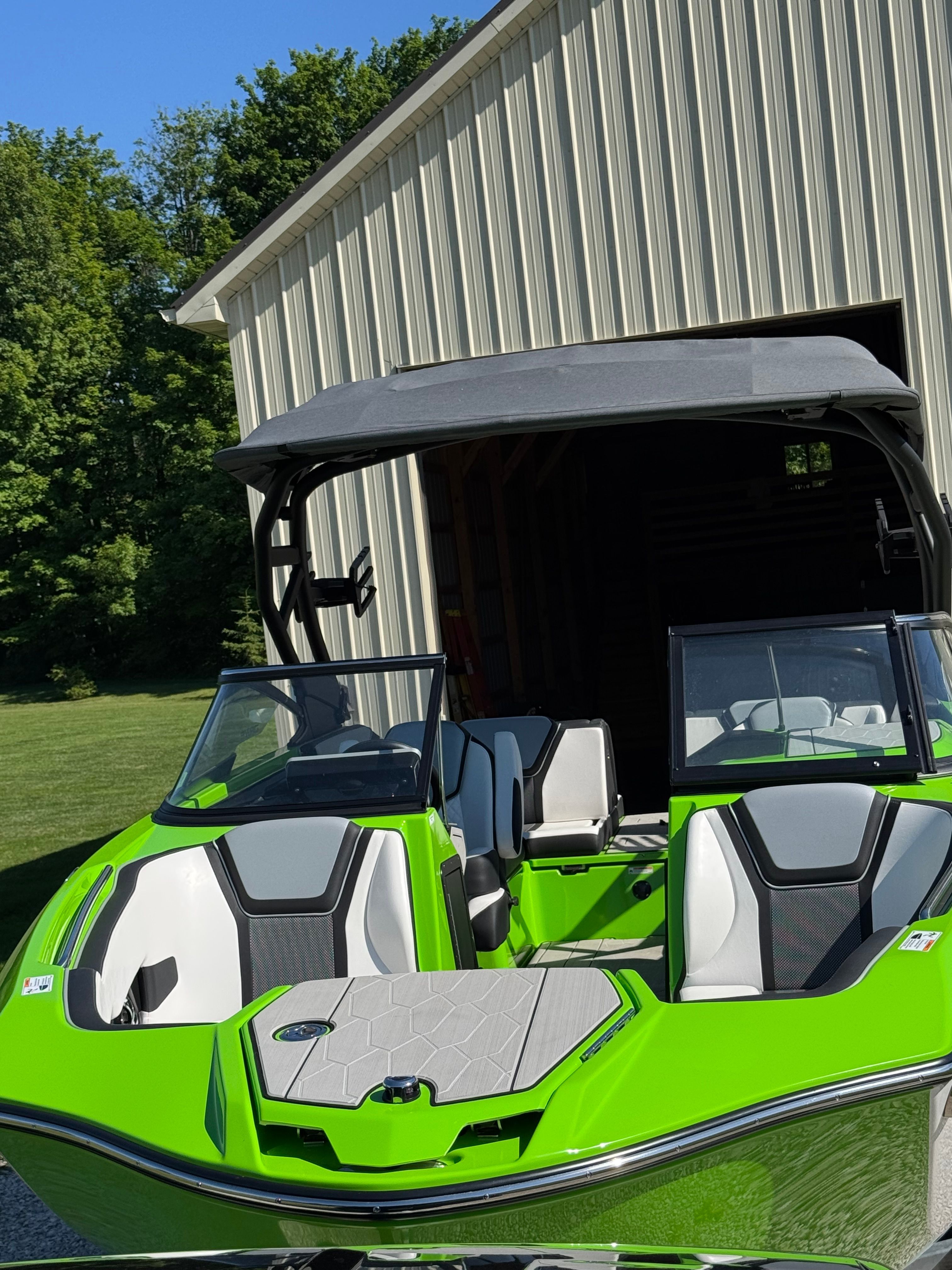 Yamaha 255XD 2022 in bright green in front of a storage building.