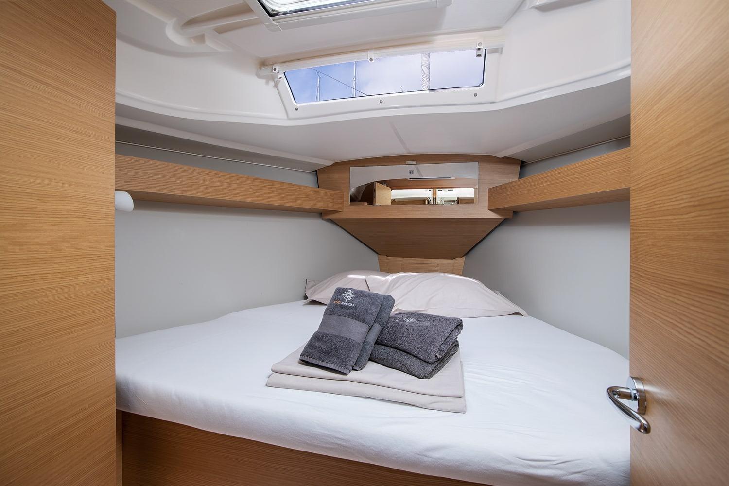 Cozy cabin interior of 2019 Dufour 360 Grand Large yacht with bed and skylight.