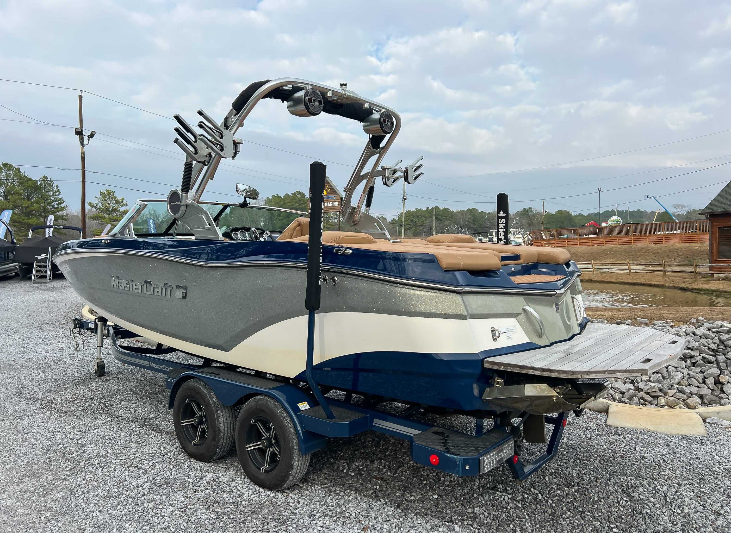 2021 MasterCraft XT22 boat on trailer, side view.
