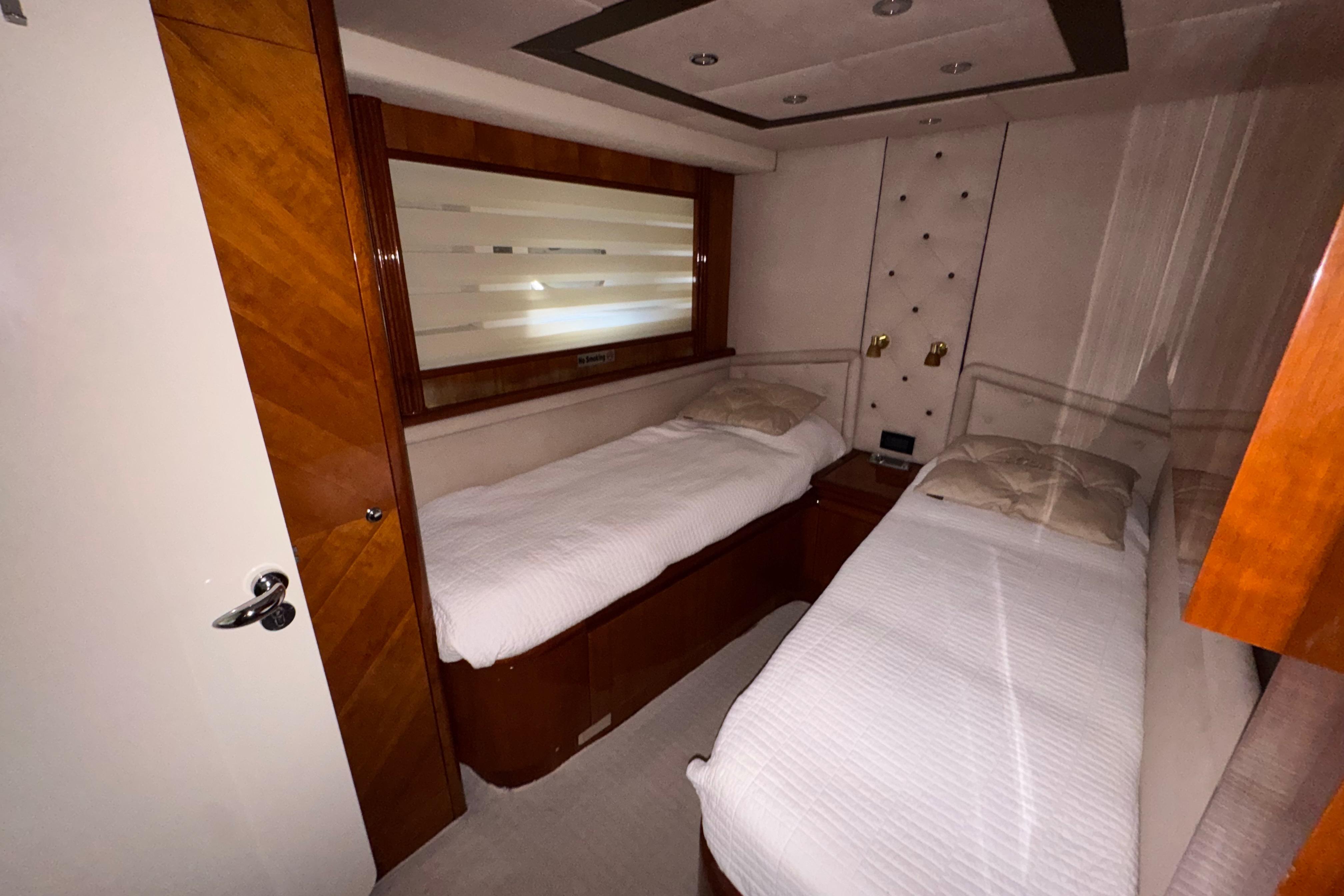 Twin cabin interior of 1998 Azimut 85 Ultimate yacht with wooden accents.