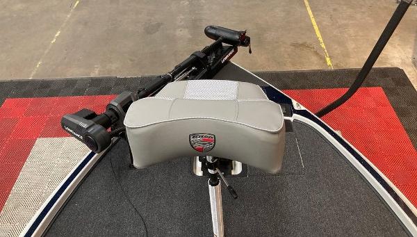 Triton 20XP 2025 boat seat with trolling motor on a carpeted deck.