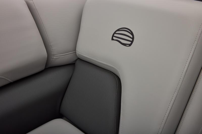 2026 Sun Tracker Party Barge 22 DLX, featuring sleek gray seating with logo detail.