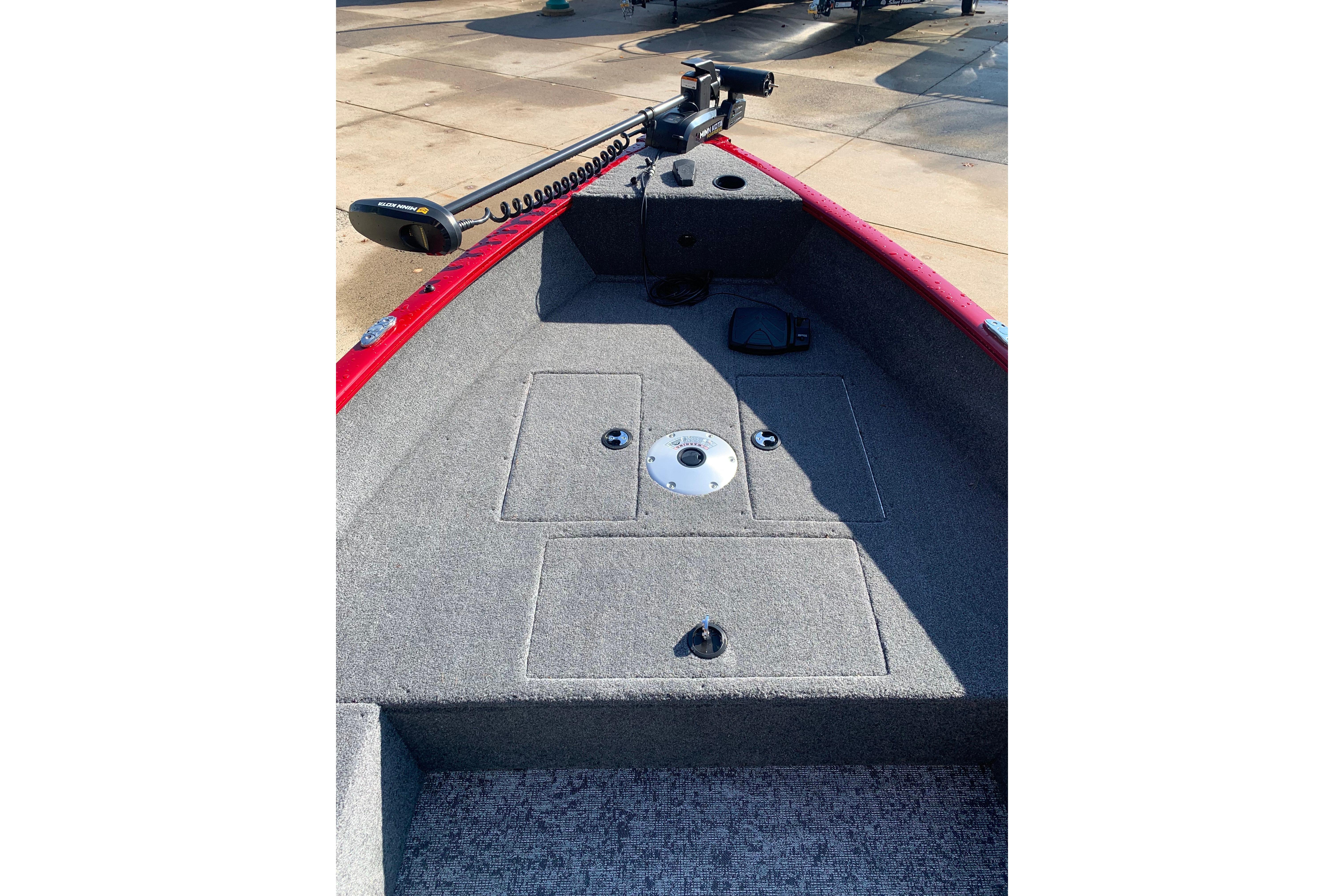 2025 Tracker Super Guide V-16 T boat interior with carpeted deck and trolling motor.