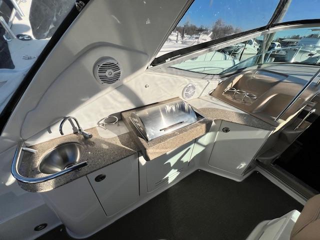 2017 Sea Ray 330 Sundancer interior with kitchenette, sink, and grill.