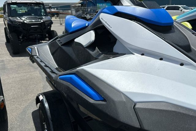 A Yamaha WaveRunner Jetblaster in black with blue accents is on a trailer.