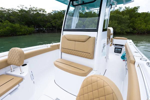 Manufacturer Provided Image: 2025 Sportsman Heritage 231 Center Console boat with tan seating, on calm water.