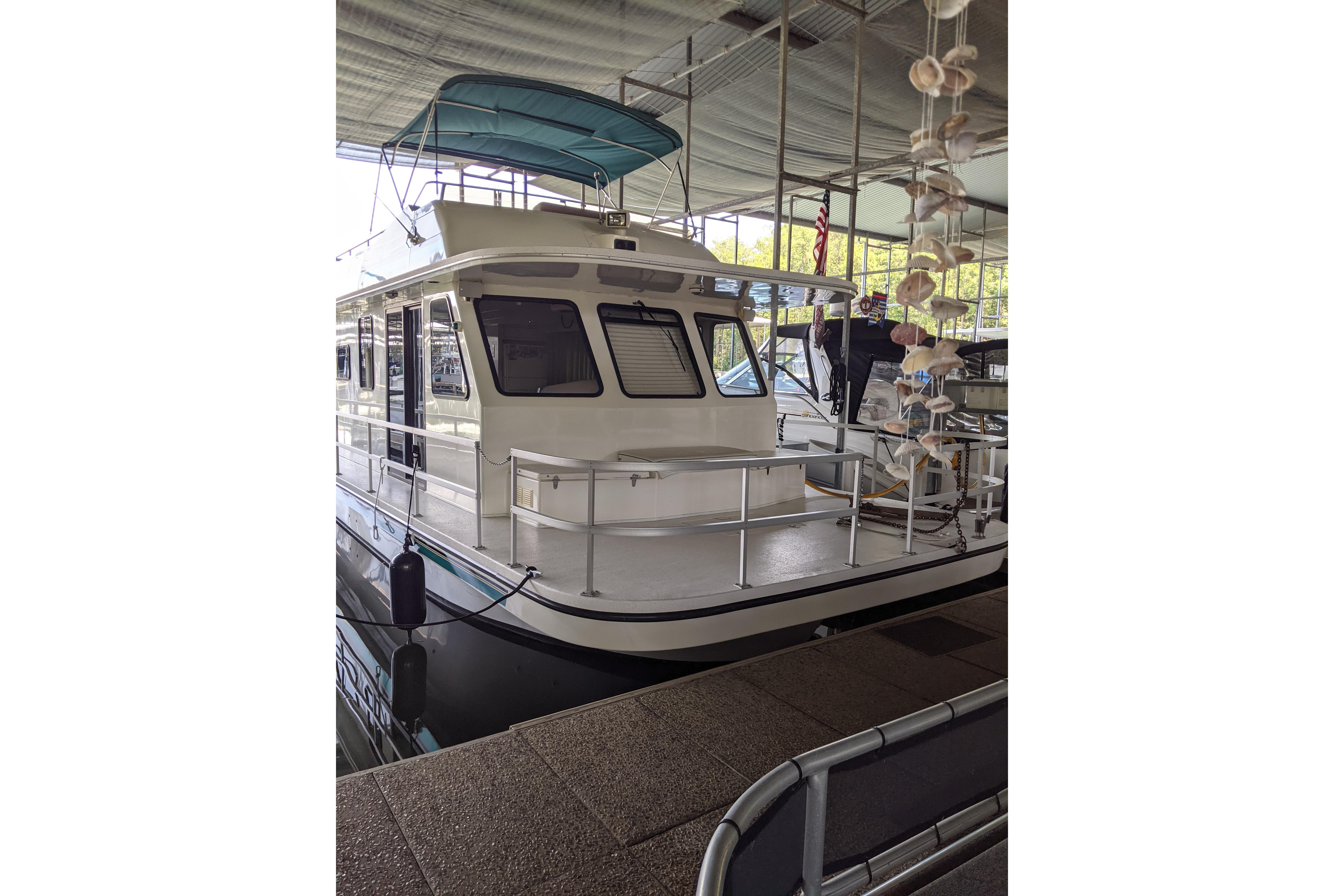 2001 Gibson 50 Cabin Yacht docked under a covered marina.